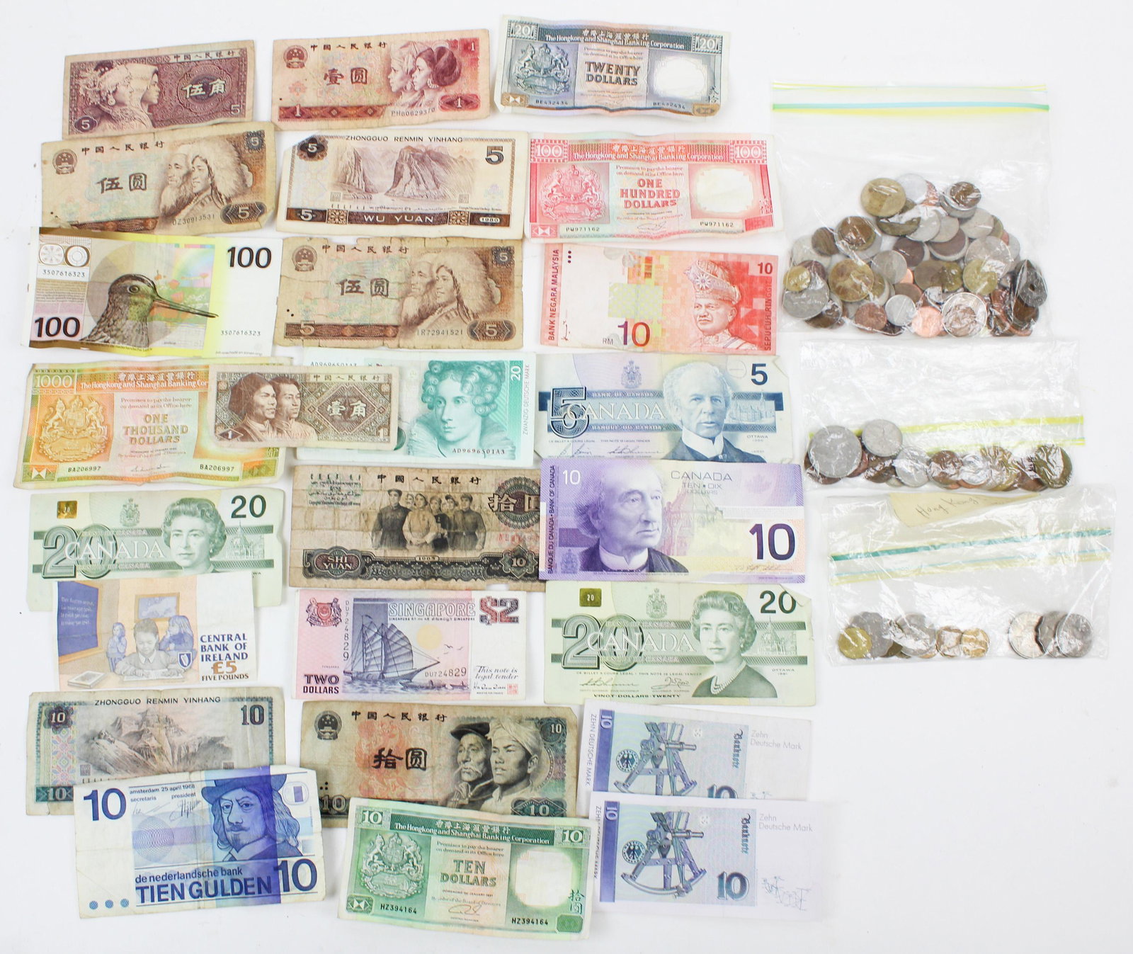 Foreign Currency: A group of foreign coins and paper currency including Hong Kong, Canadian, Zhongguo Renmin Yinhang, a $1000, $100, $20, $10 bank notes from the Hongkong and Shanghai Banking Corporation.