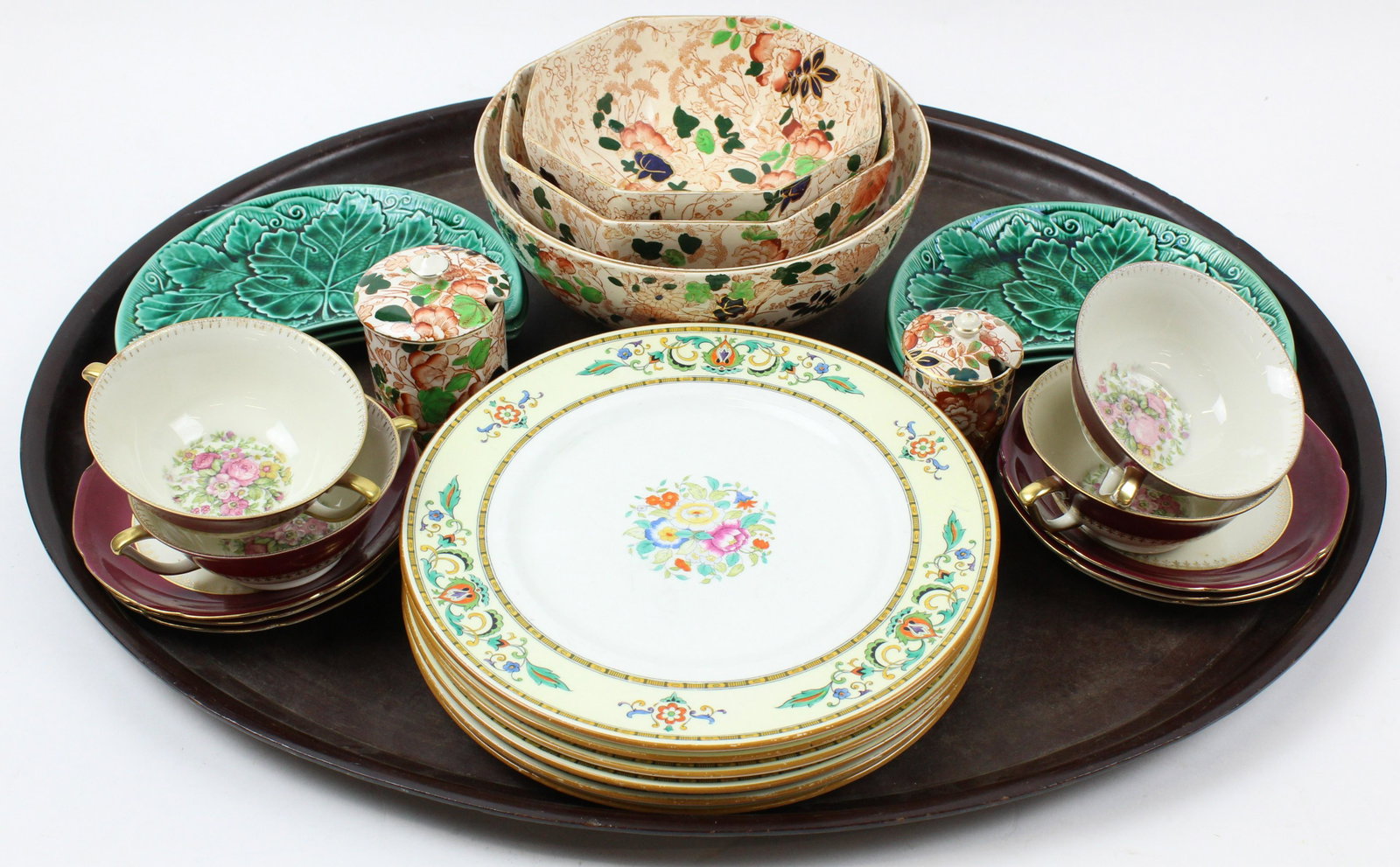 Lot of English and European Porcelain: Lot of European porcelain tableware including 5 Wedgwood green majolica side dishes, 4 Czechoslovakian bouillion soups, 5 pcs. Royal Cauldon Imari style calico decorated serving items, and 6 Cauldon b