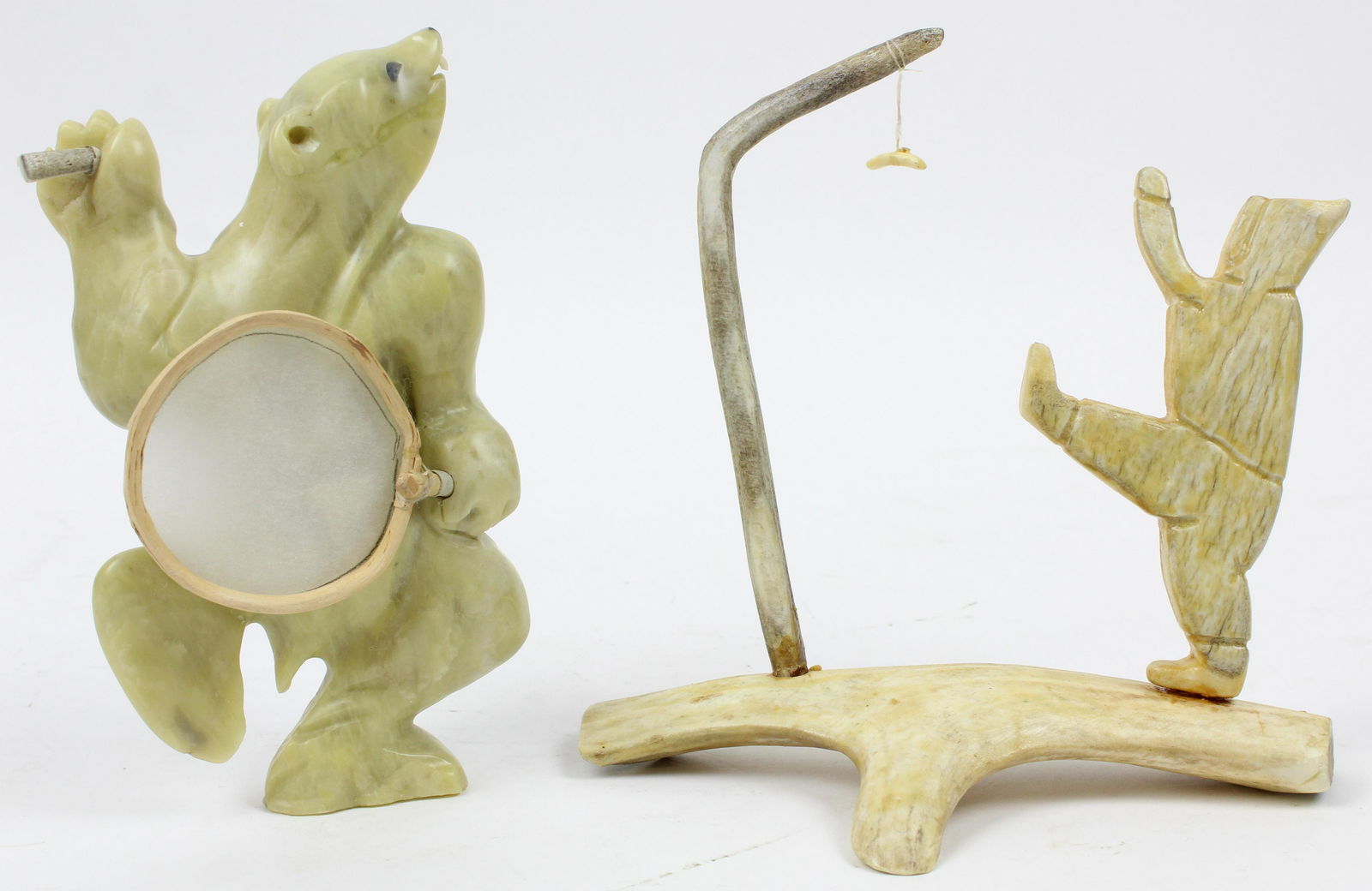 Inuit Stone, Bone Carvings: Inuit stone carving of a Bear with a drum, labeled Joseph Kavik, Rankin inlet, 2010, sold with a bone carving of a one-foot high kick player initialed GFE on base, hts 8", 7 1/2"