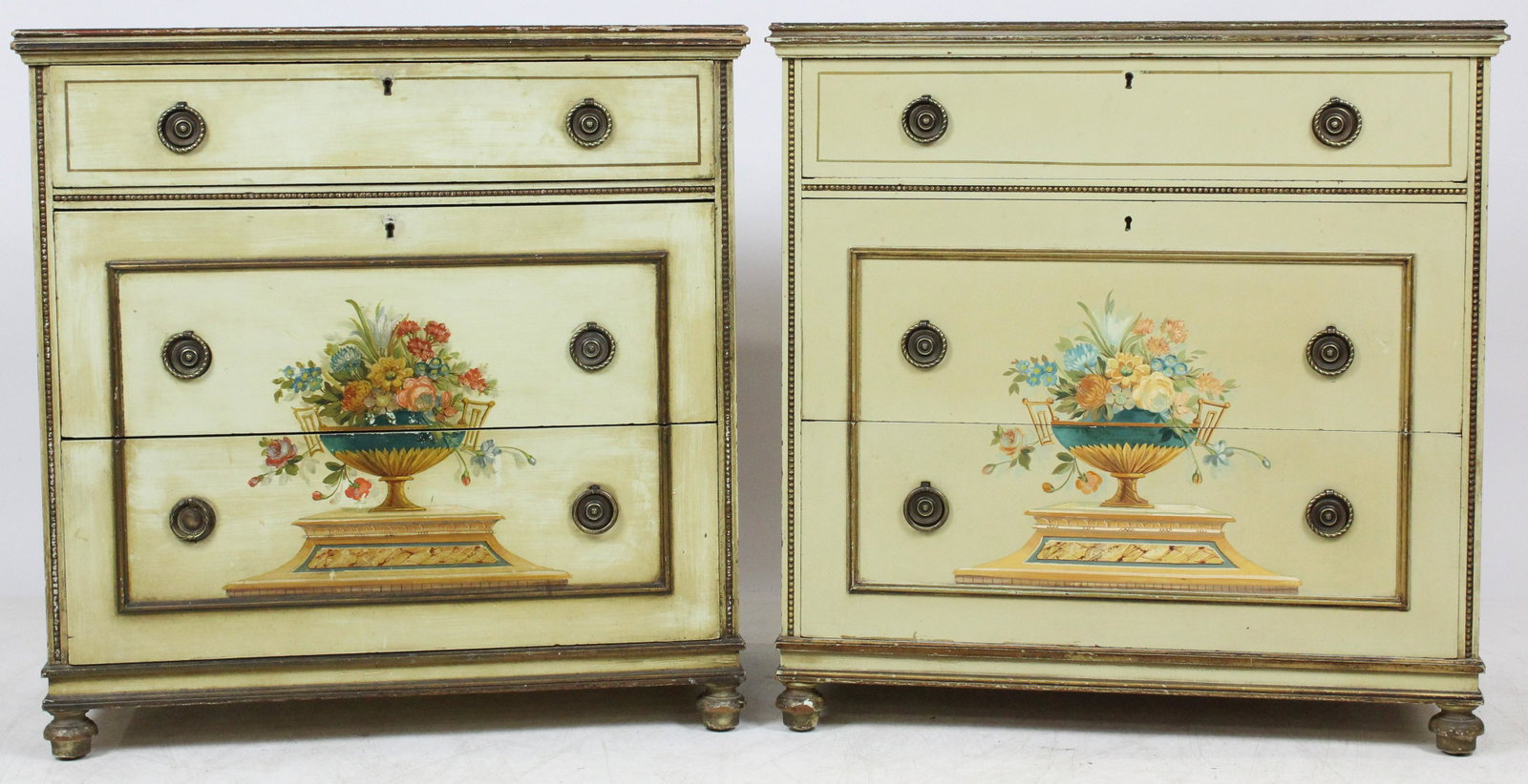 Pair of Paint Decorated Chests: A pair of 3 drawer paint decorated mid 20th c chests. Cream background color with free hand floral and compote decoration. Round drop bail pulls. 30" w, 18" d, 31"h.