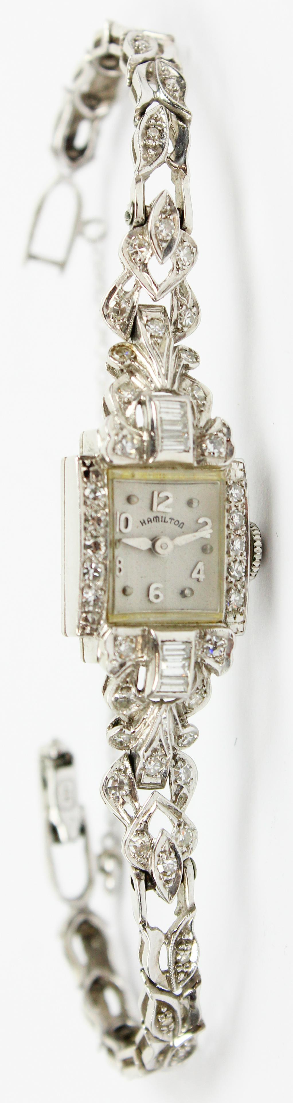 Hamilton Ladies Diamond Wrist Watch: A 14k white gold ladies wrist watch. Face and band set with over 50 round cut or baguette cut diamonds. Band marked 14k. Approx. 1.5 cts t.w. in diamonds. 14 mm wide case. 18.7 grams t.w.