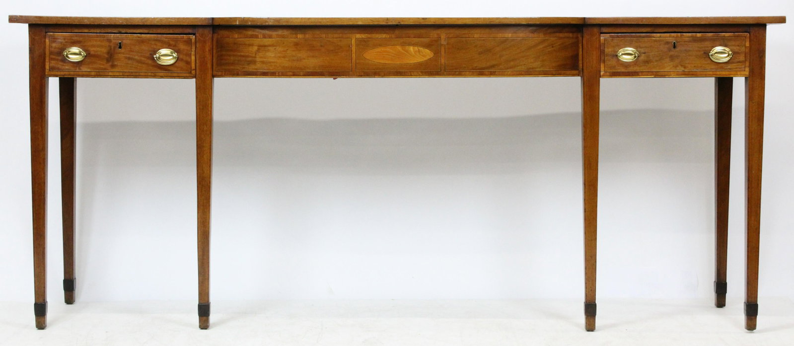 English Hepplewhite Mahogany Server: A fine early 19th c English mahogany Hepplewhite style server. Hunt board style. Bowed center section with single drawer on either side. String, banded, & oval inlay. Tapered legs with cuffs. 82" long