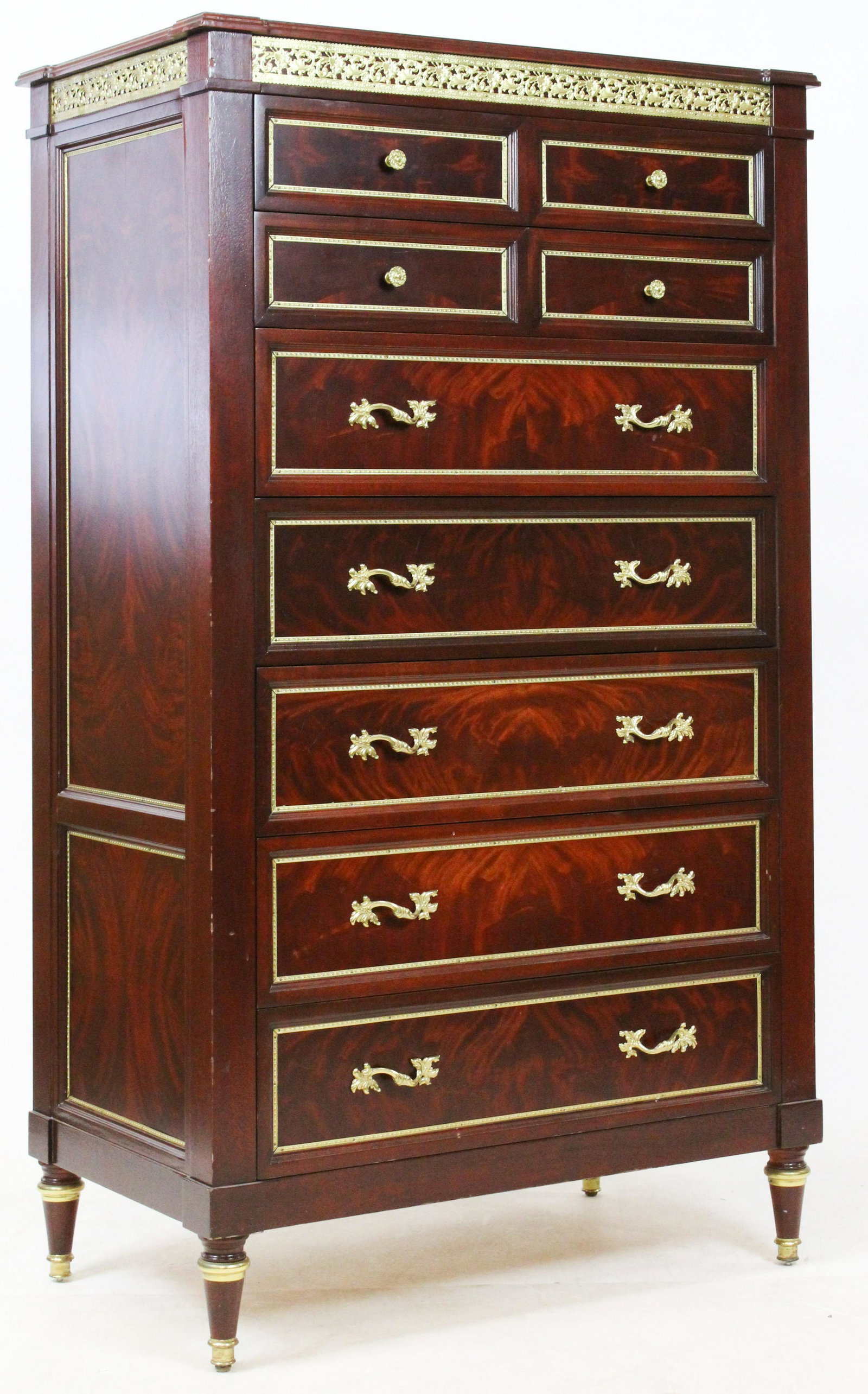 20th Classical Ormolu Mounted Tall Chest: 20th c mahogany tall chest. 4 small drawers over 5 long drawers. Gilt brass drawer surrounds, panel surrounds, and under top edge. 62" h, 35" w, 22" deep.