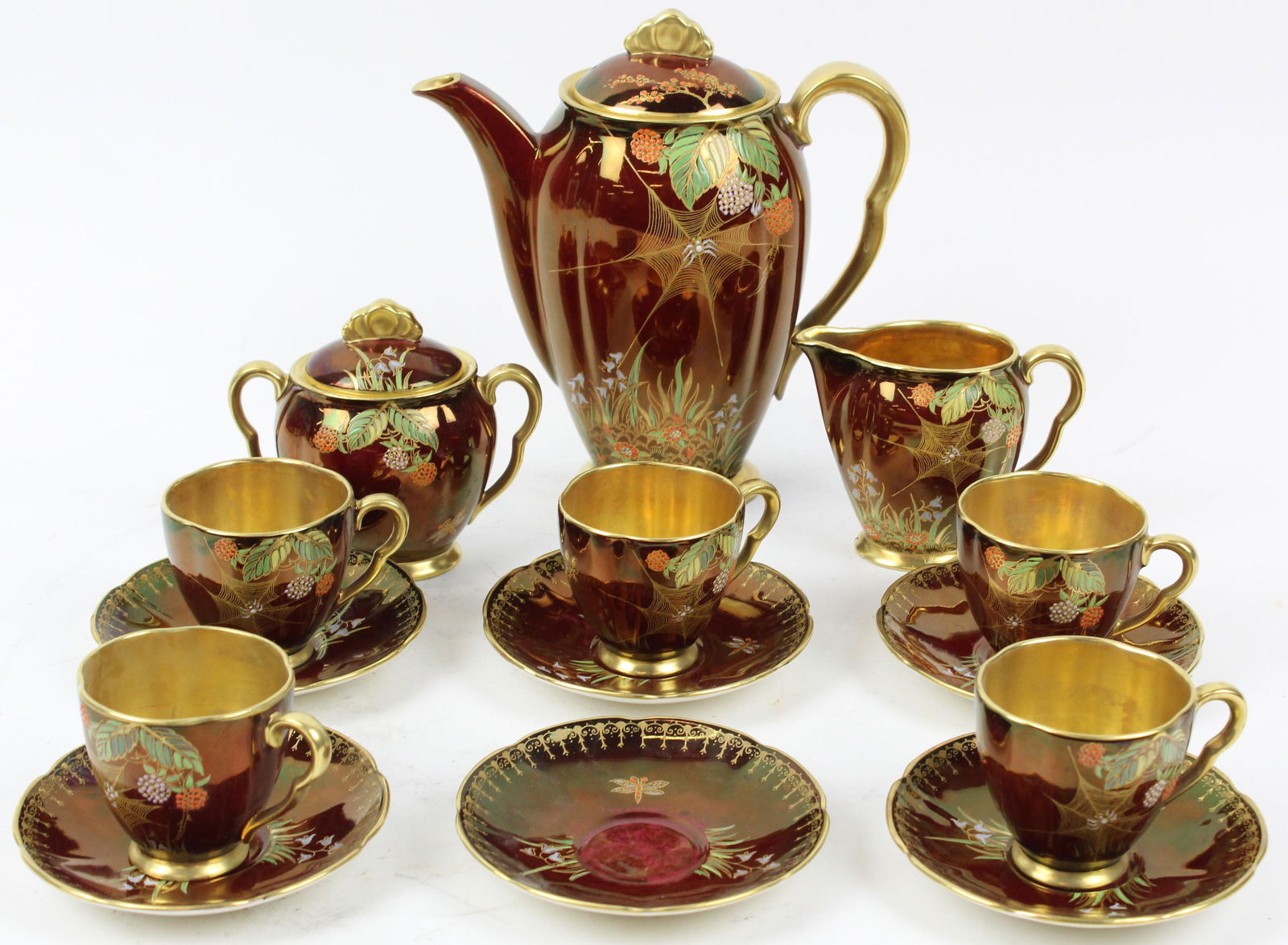 Carlton Ware Rouge Royale Demitasse Set: Carlton Ware "Rouge Royale" English porcelain demitasse set consisting of cocoa pot, sugar and creamer, and 5 cups and saucers, all having tropical flora raised enamel decoration with red iridescent g