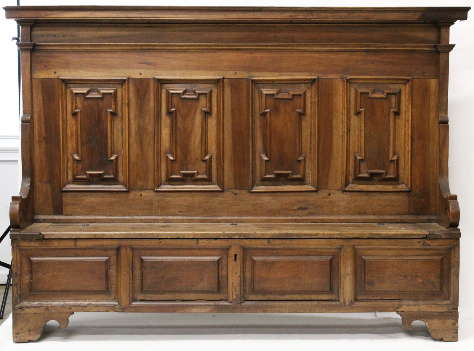 17th /18th c Contented Settle or High Back Pew: 17th / 18thc walnut Continental Florentine high back settle or liturgical pew. Cornice molded top, 4 molded panel back, lift bench seat, 4 raised panels, & bracket base. All hewn, early iron with rose