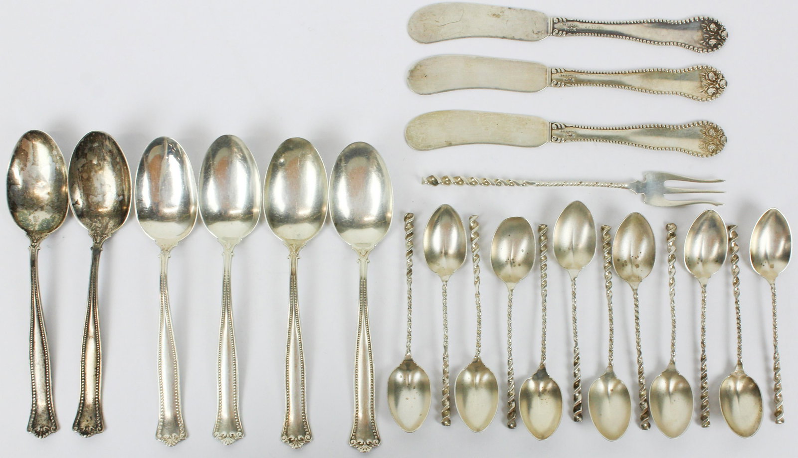A Group of Late Victorian Sterling Flatware: 22 pcs. late Victorian sterling silver flatware including 3 Gorham "Lancaster" 3 butter spreaders, 6 Gorham beaded edge teaspoons, 12 Whiting twist handle demitasse spoons and olive fork 4"-5.5" 7.6 t