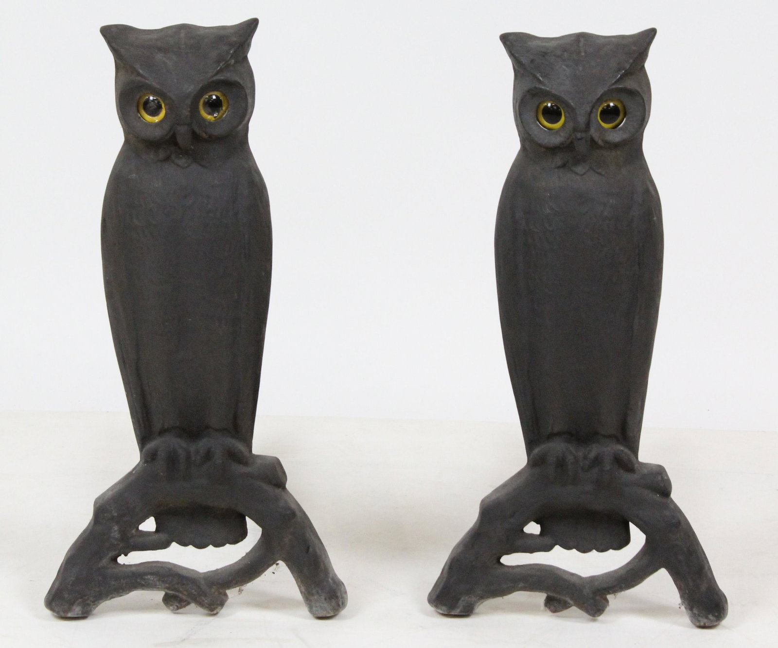 Pair of Cast Iron Figural Owl Glass Eyed Andirons: Pair of early 20th c. cast iron figural owl andirons with inset glass fire-light eyes, from Point Farm West Grand Isle, VT 22" x 11" x 20" -one glass eye with crack, as found