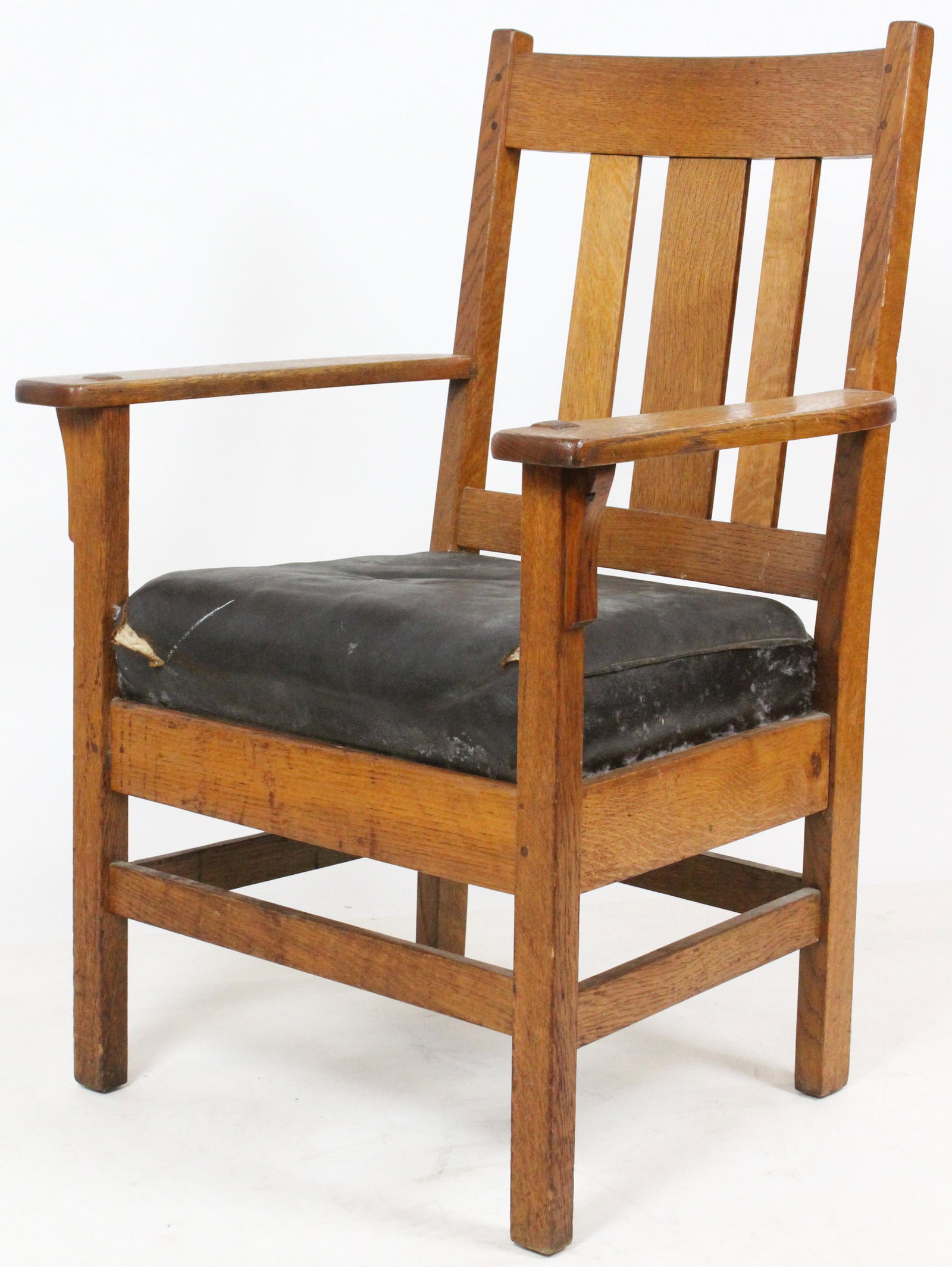 J. M. Young Mission Oak Armchair: Labeled J. M. Young Camden, NY mission style oak Arts and Crafts era slat back armchair with pegged construction, through tenon arms, and original leather slip seat 39" x 27" x 23" -older refinish, we