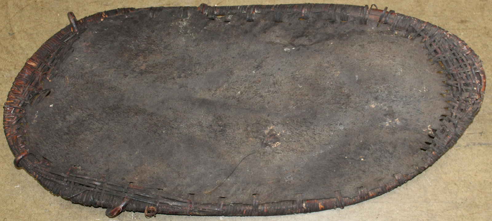 Paupua New Guinea Leather Sheild: Papua New Guinea Leather Sheild with Rattan binding, 21 x 46"