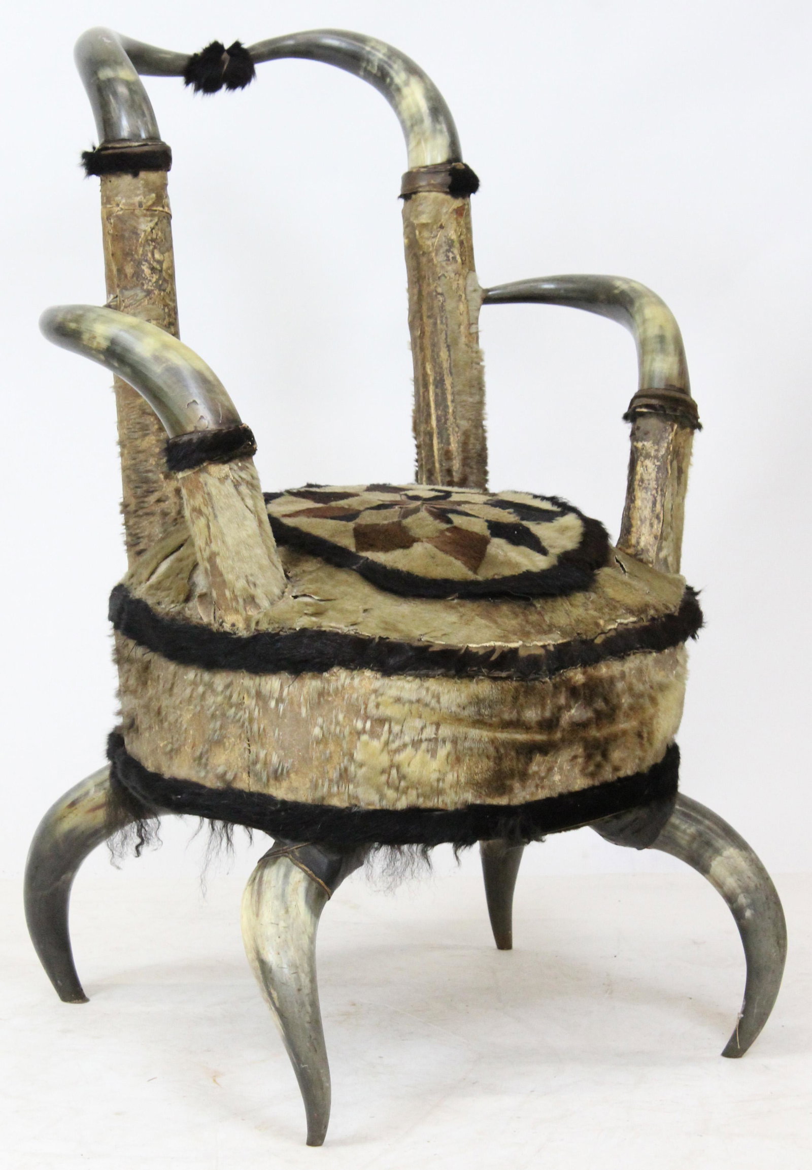 Late 19th c. Western Steer Horn Armchair: Late 19th c. Western steer horn armchair with patchwork hyde covered seat 34" x 24" x 24" -some losses to hyde, splits to seams