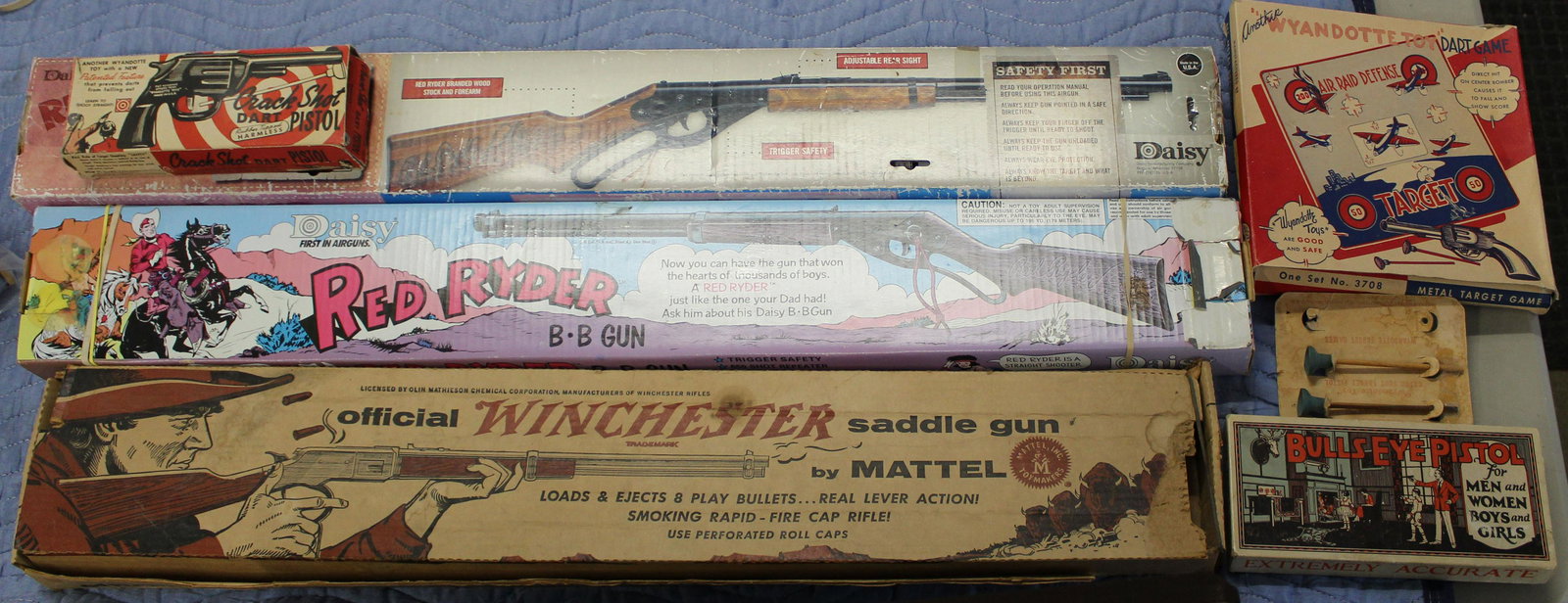 Lot of Pellet and Dart Guns: Lot of Pellet and Dart Guns, Two Red Ryder BB Guns in original Boxes, Winchester Saddle Cap Gun in box, Wyandotte Crack Shot Dart Pistol with paper card and three darts, Bulls-Eye Pistol for Men and W