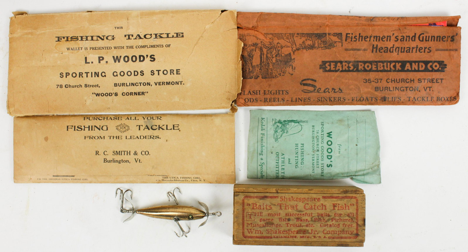 Shakespeare Copper Minnow in Box Vermont Paper: A group of 5 pieces of advertising for L P Wood's Sporting Goods Burlington, Vermont. 4 paper folders for hooks or paper work. One small wooden lure box marked Wood's Sporting Goods Store Burlington, 