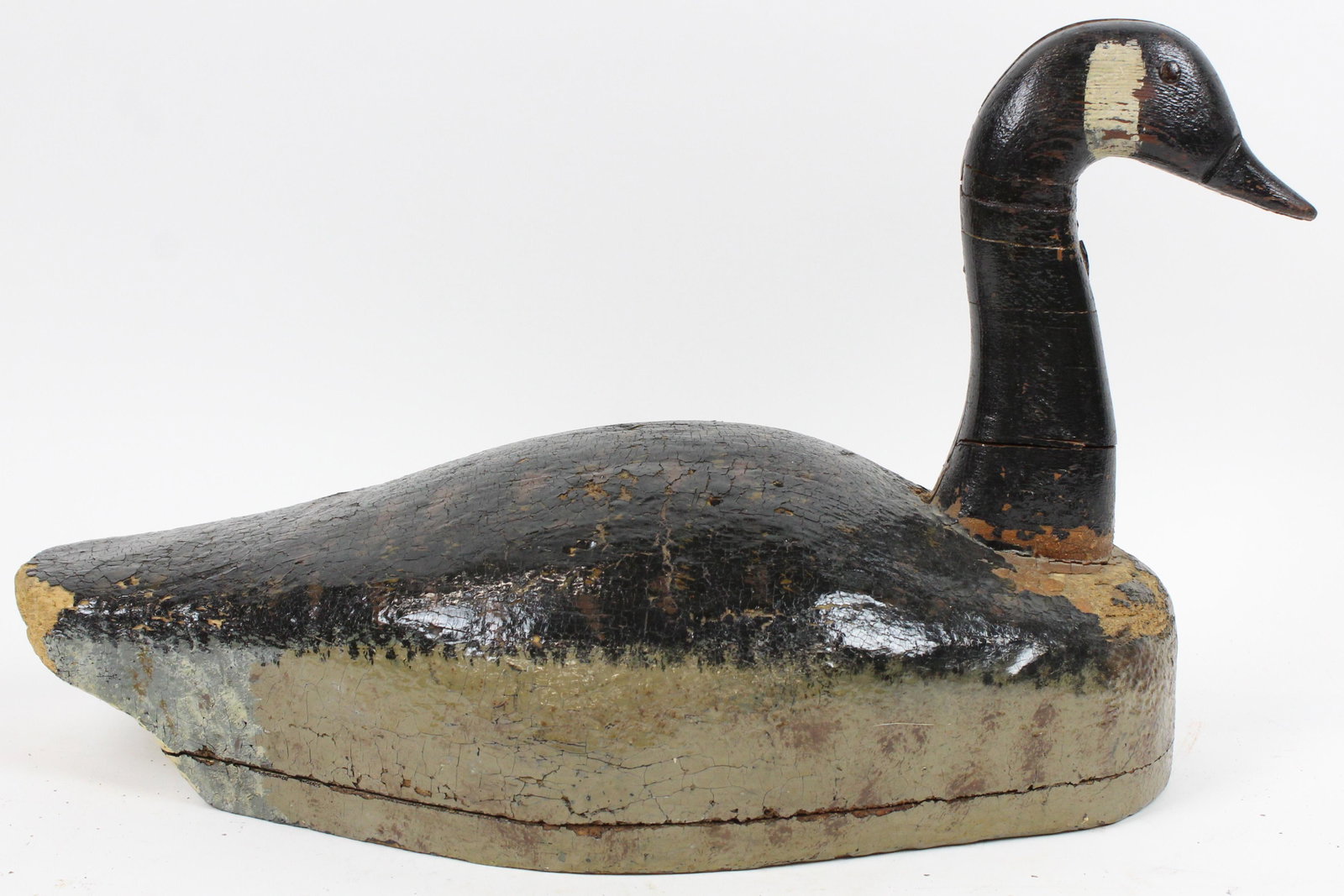 Rhode Island Goose Decoy: Early 20thc Providence, RI Canadian Goose decoy. Two part body, tack eyes, weights missing, old repairs, varnished. 20" long, 12" high.