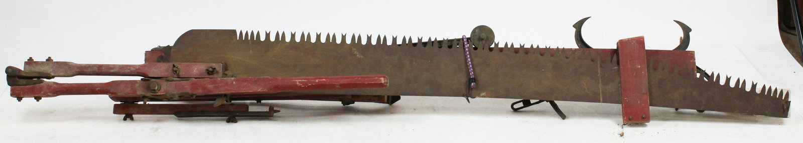 Early 20th c. Folding Sawing Machine: Early 20th c. Folding Sawing Machine forestry tool , designed to allow a woodsman to do the work normally required by a two man saw crew (pre-chain saw), in old red paint with advertising stencil, wit