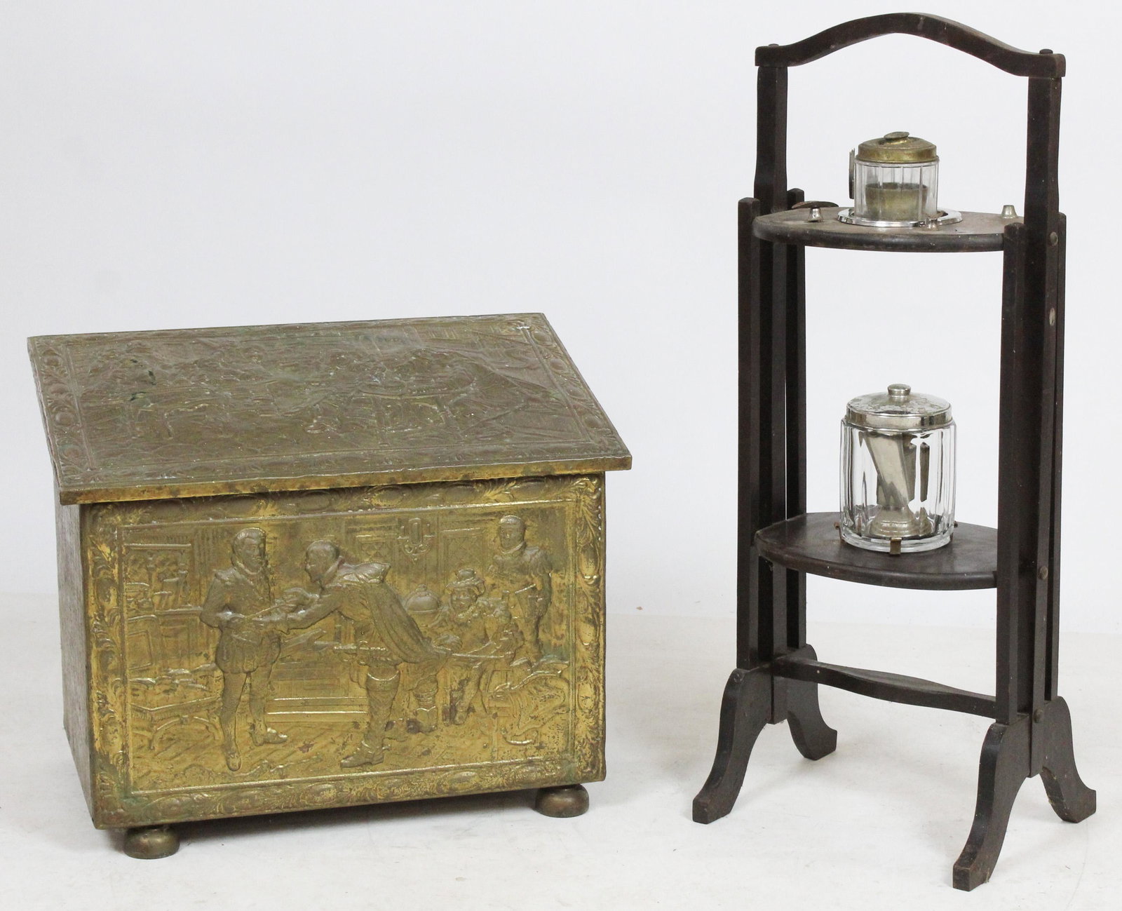 English Brass Kindling Box and Smoking Stand: ca. 1930 English brass covered kindling box with embossed tavern scene panels, accompanied by a dark stained wooden smoking stand with ashtray and tobacco jar 17" x 20.25" x 13", 30" x 12" x 10"