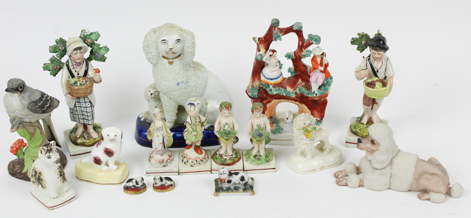 16 Staffordshire and Other Porcelain Figurines: Group of 16 porcelain figurines including Staffordshire mantel figures, small pearlware glaze miniature figurines, 2 Edward Marshall Boehm bisque figurines (bird and poodle), etc. 1.5"-7" -many with l