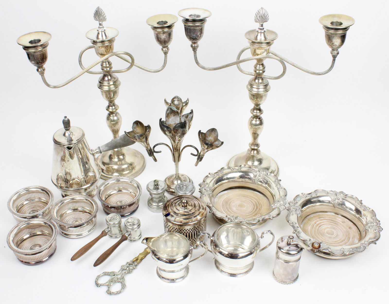 Group of Fine Silverplated Hollowware: Group of fine silverplated hollowware including Art Nouveau style centerpiece epergne, pair of bottle coasters, 4 small bottle coasters, pair of candelabra, pepper mill, sugar and creamer set, cobalt