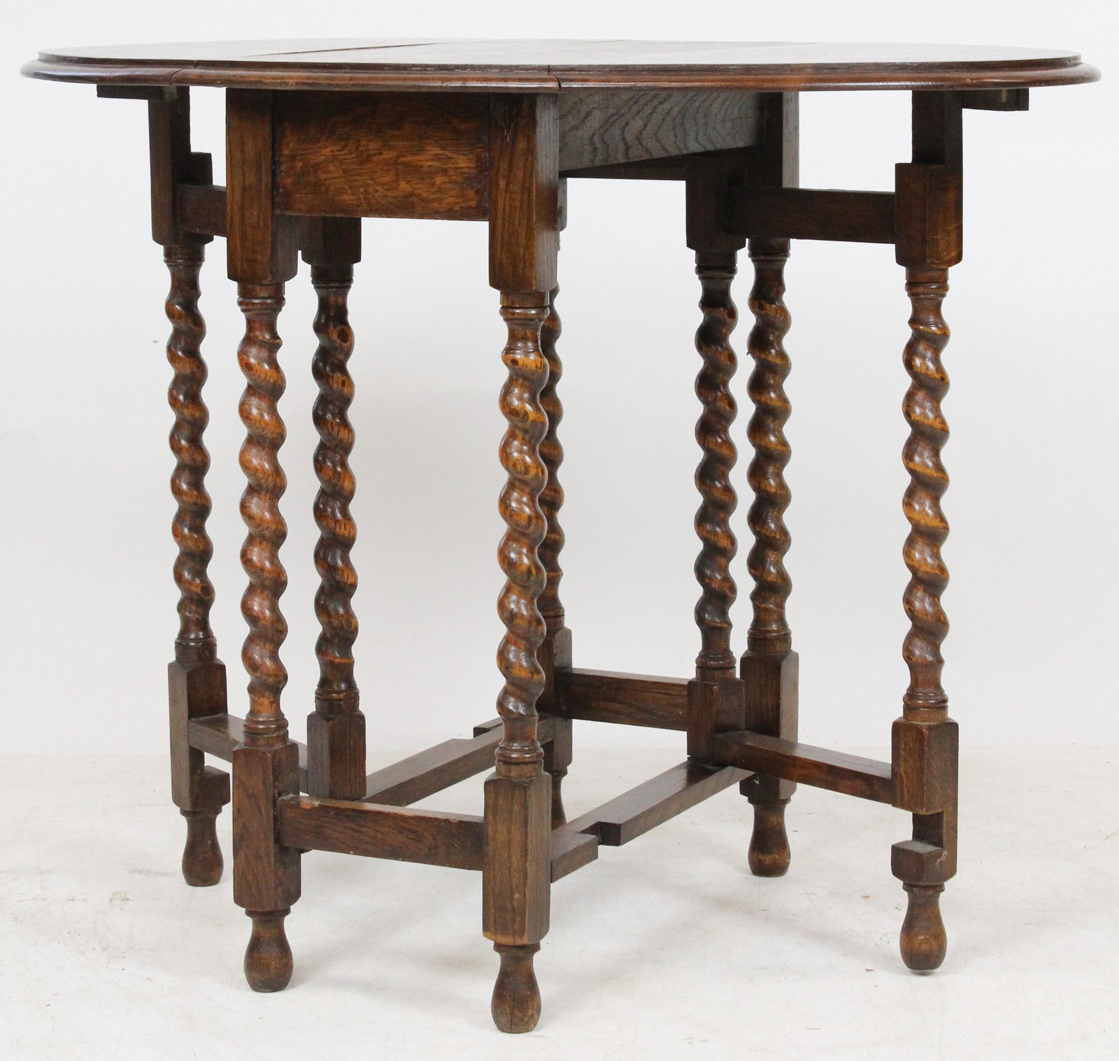 Colonial Revival Oak Butterfly Table: Fine small early 20th c Colonial Revival tiger oak butterfly or small gate leg table. Rope twist legs, oval top, swing leg support. Good clean older surface. 24" long, 13" wide, 29" high.