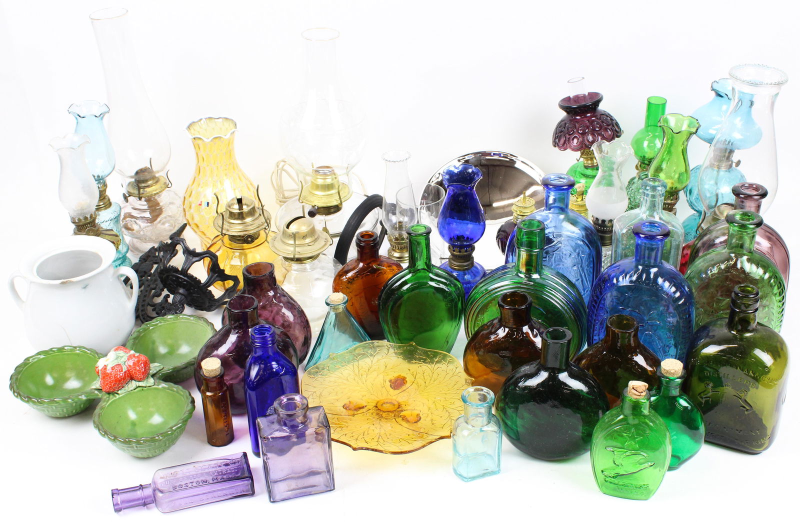 Replica Miniature Oil Lamps and Colored Bottles: Large lot of 2 boxes of mid 20th c. replica miniature colored glass oil lamps, and bicentennial era colored glass reproduction flask bottles, accompanied by a Victorian cast iron bracket oil lamp with