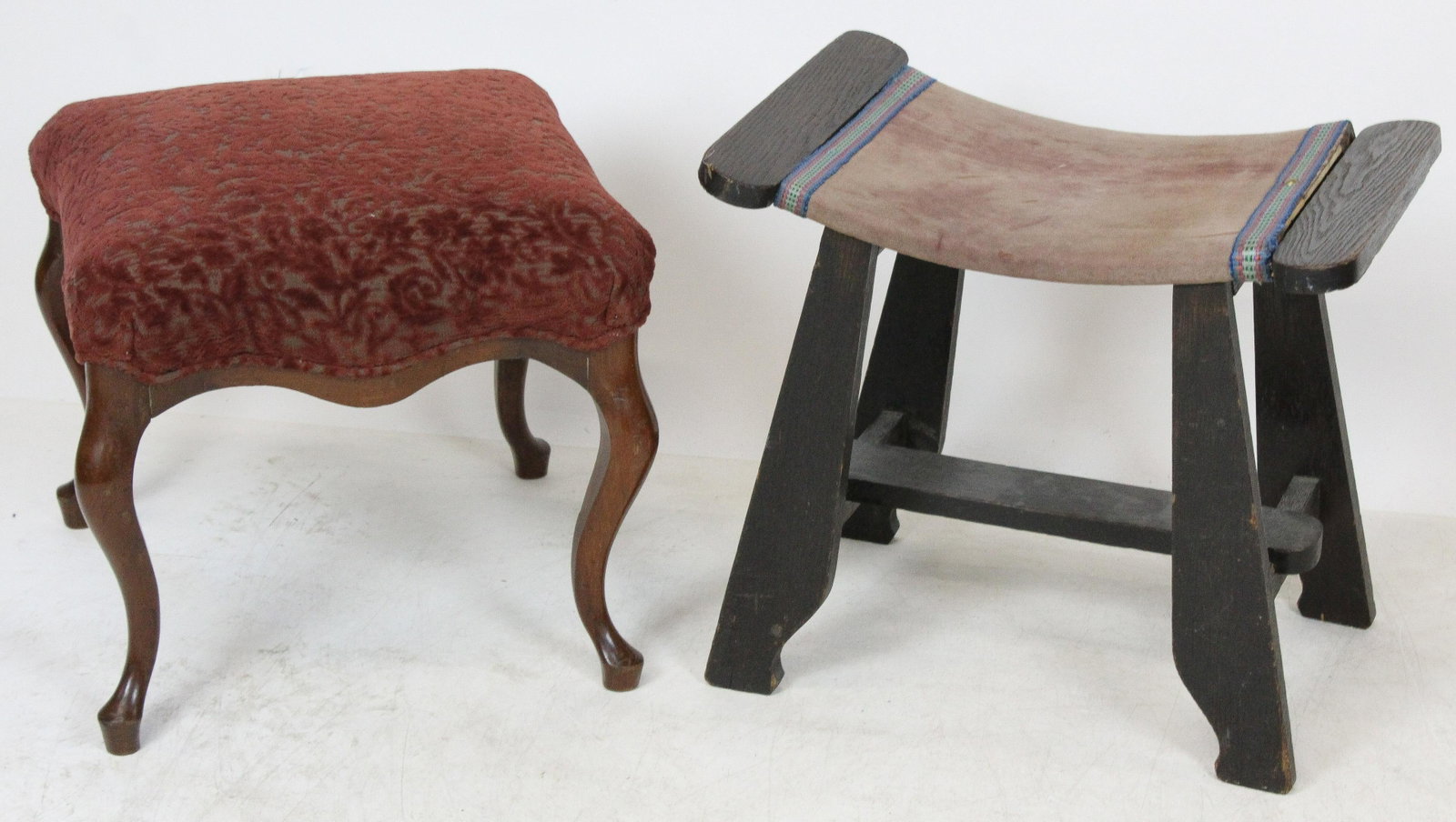Two Turn of the Century Upholstered Ottomans: Two Turn of the Century ottomans including Victorian walnut cabriole leg ottoman in fine burgundy cut velvet upholstery, and Mission style Arts and Crafts era hearth bench in suede type upholstery-one