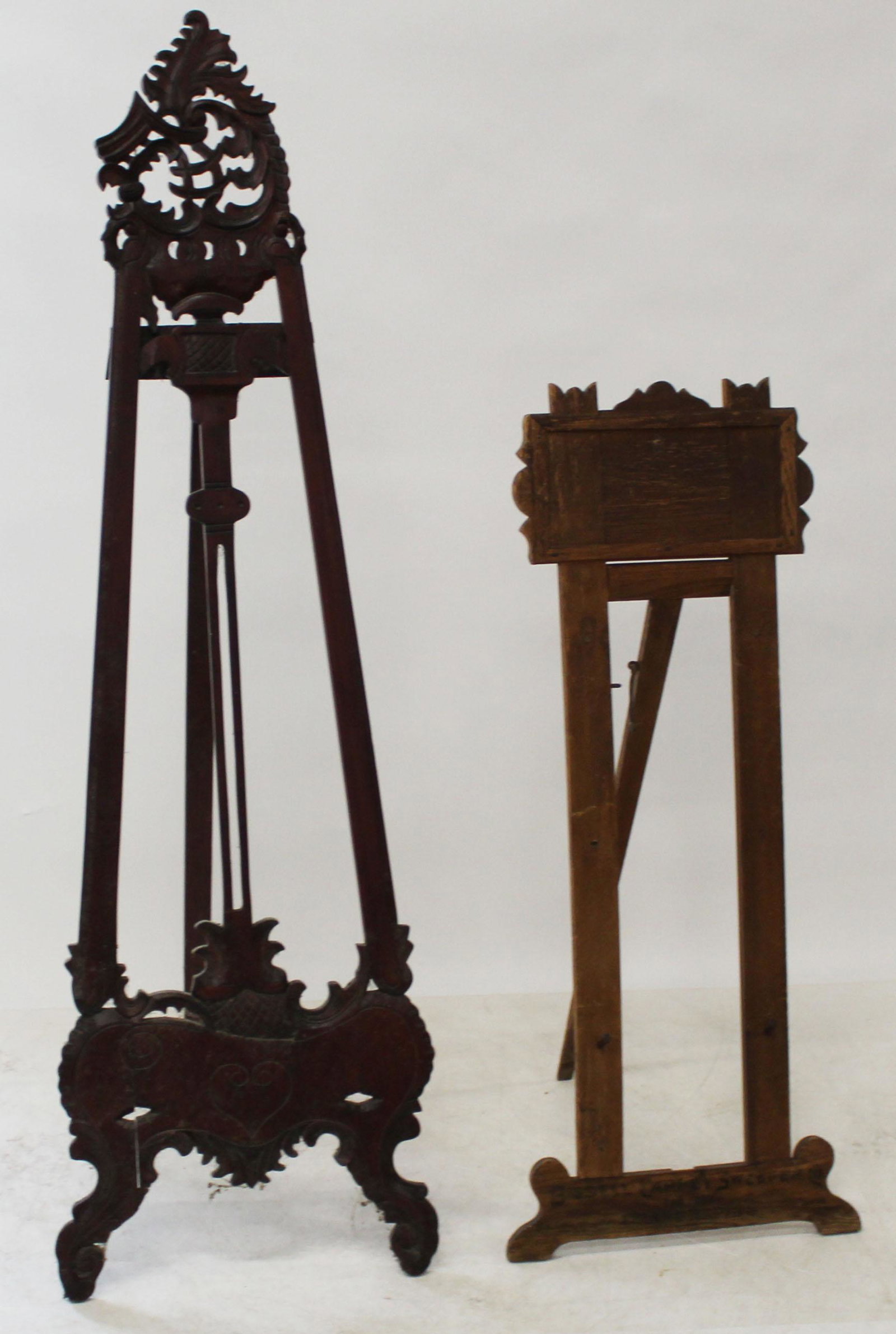Two Easels: Two Easels one 19th c oak one 20th c in mahogany or tropical wood most likely indonesian 48" and 67" respectively