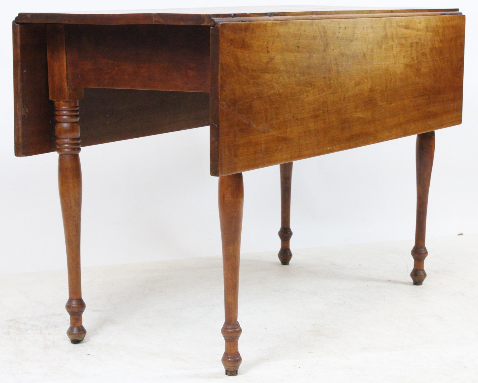 VT Sheraton Drop leaf Cherry Table: A Vermont Sheraton cherry drop leaf table. Birch or maple legs. Refinished, clean. 42" l x 27" h x 20" w. Sold to benefit the Waitsfield United Church of Christ.