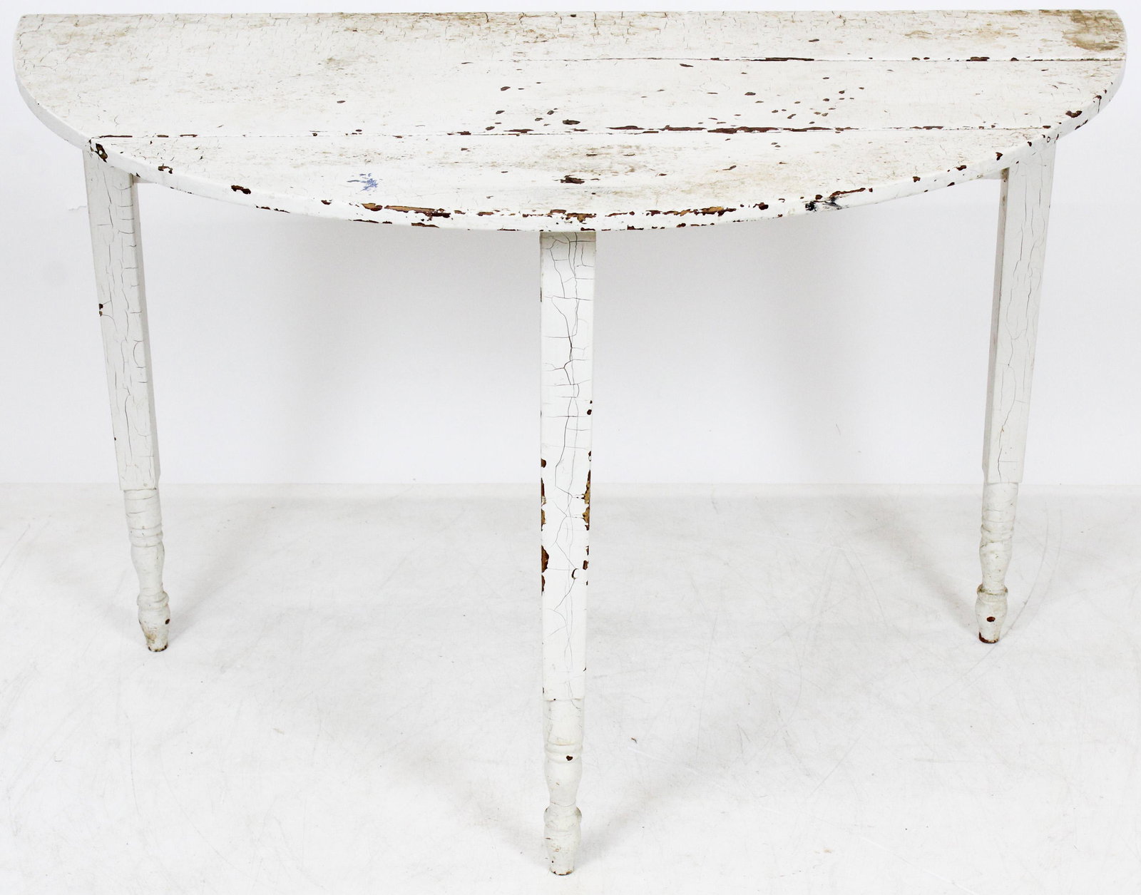 19th c Country Demilune table in old white: 19th c Country Demilune table in White with traces of Spanish brown and blue paint with block turned legs (most likely upstate NY) 44 x 21 x 28"