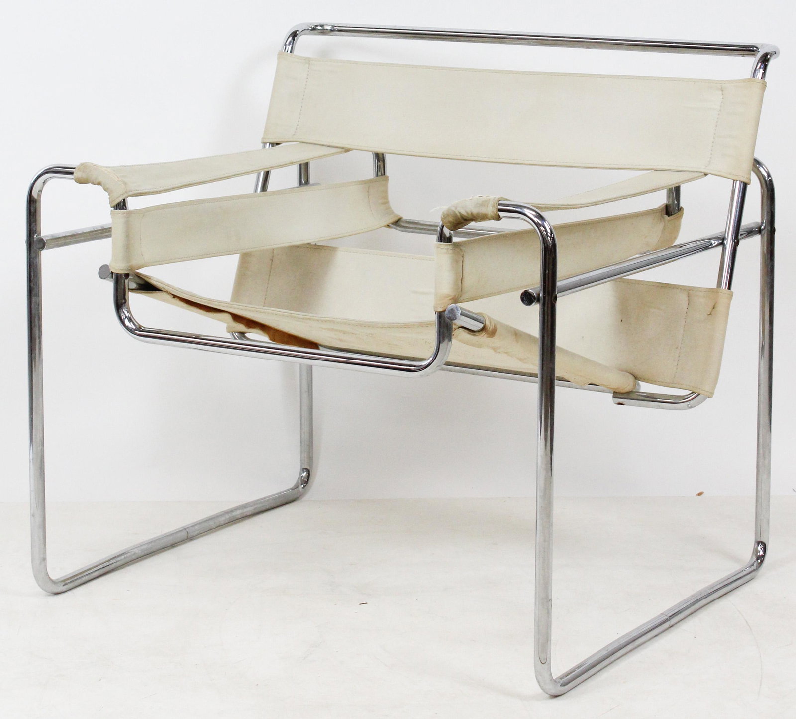 Wassily Armchair: Marcel Breuer Wassily armchair. Nickel plate steel tube, covered in cream iron yarn. Stains & worn spots. Arm ends with tears. Allen wrench construction. Possibly special edition for Knoll Internation