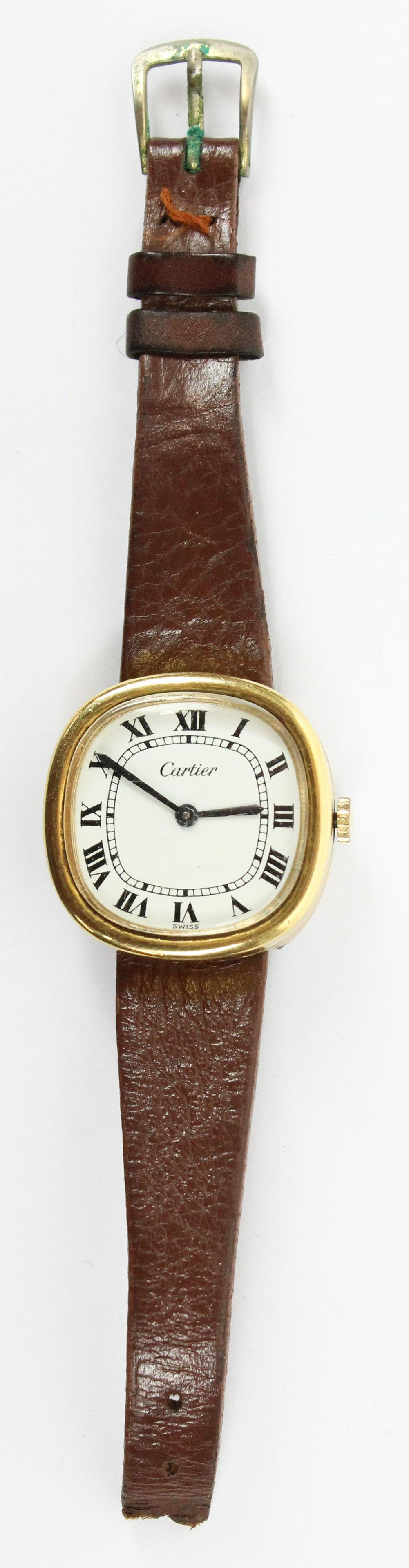 Ladies Cartier Wrist Watch: Vintage ladies Cartier wrist watch. Gold rounded edge square case, Roman numerals, Cartier signed face, back of case signed Cartier. Slight curve to back of case. 25mm x 26 mm. Leather band damaged. N