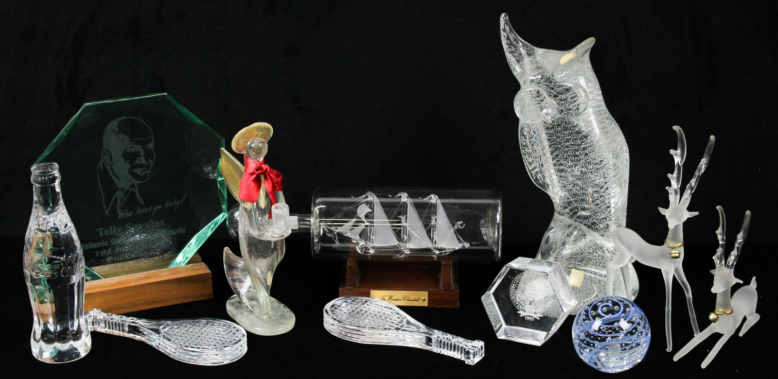 Art Glass Novelty Items Incl. Waterford, Etc.: Group of 11 art glass novelty items including 2 signed Waterford tennis racket paperweights, crystal Coca Cola bottle paperweight, seed bubble blue swirl paperweight, 1993 Clinton Gore Inauguration en