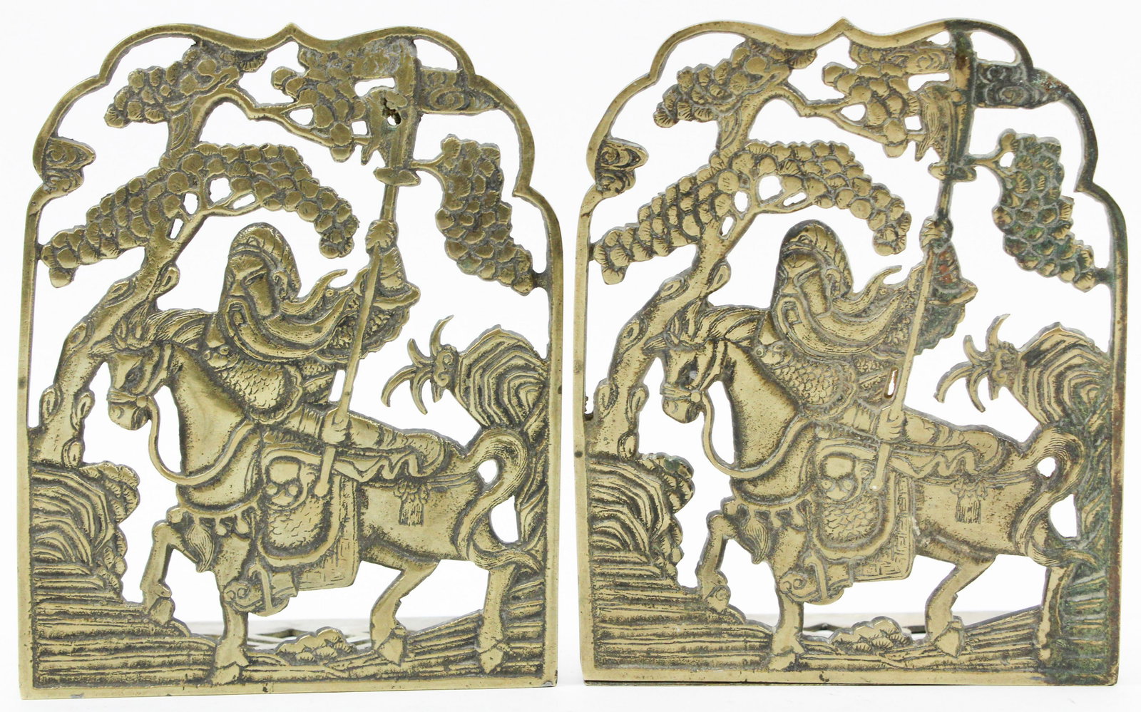 Early 20th c Chinese Brass Folding Bookends: Early 20th c Chinese brass folding bookends, depicting a fierce warrior on horseback, one hinge partially separated, 8" x 6 1/2"