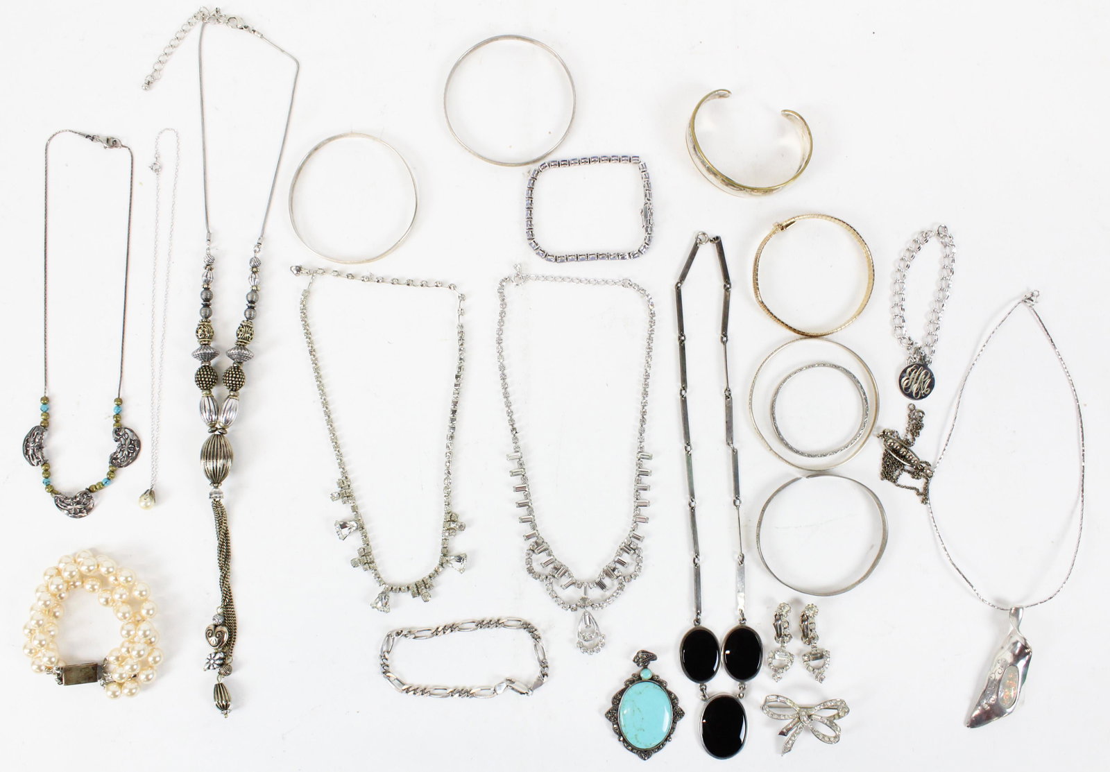 Sterling & Designer Jewelry: A group of sterling and designer jewelry including a Jackie Kennedy Classic faux pearl bracelet, a fine turquoise and marcasite pendant, a sterling and onyx necklace, a sterling twist modern necklace 