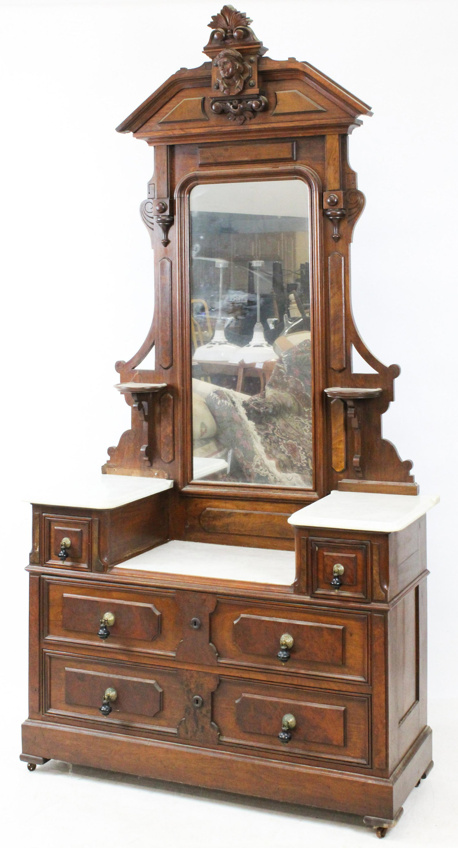 Victorian Marble Top Dresser With Figural Crest: Fine Victorian Renaissance Revival black walnut deep well marble top dresser having two over two drawers with applied burl panels and ebonized drop pulls, surmounted by tall mirror featuring carved th