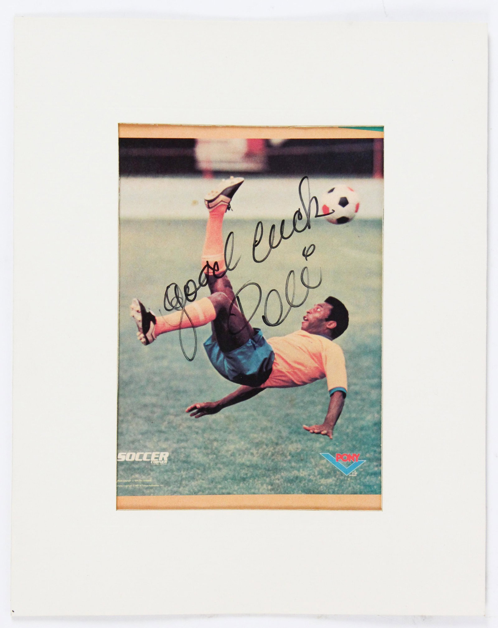 Pele: (1940- ) 1978 magazine advertisement signed "Good luck Pele", signature and inscription in sharpie, taped to mat, 4 1/2" x 6 1/2"
