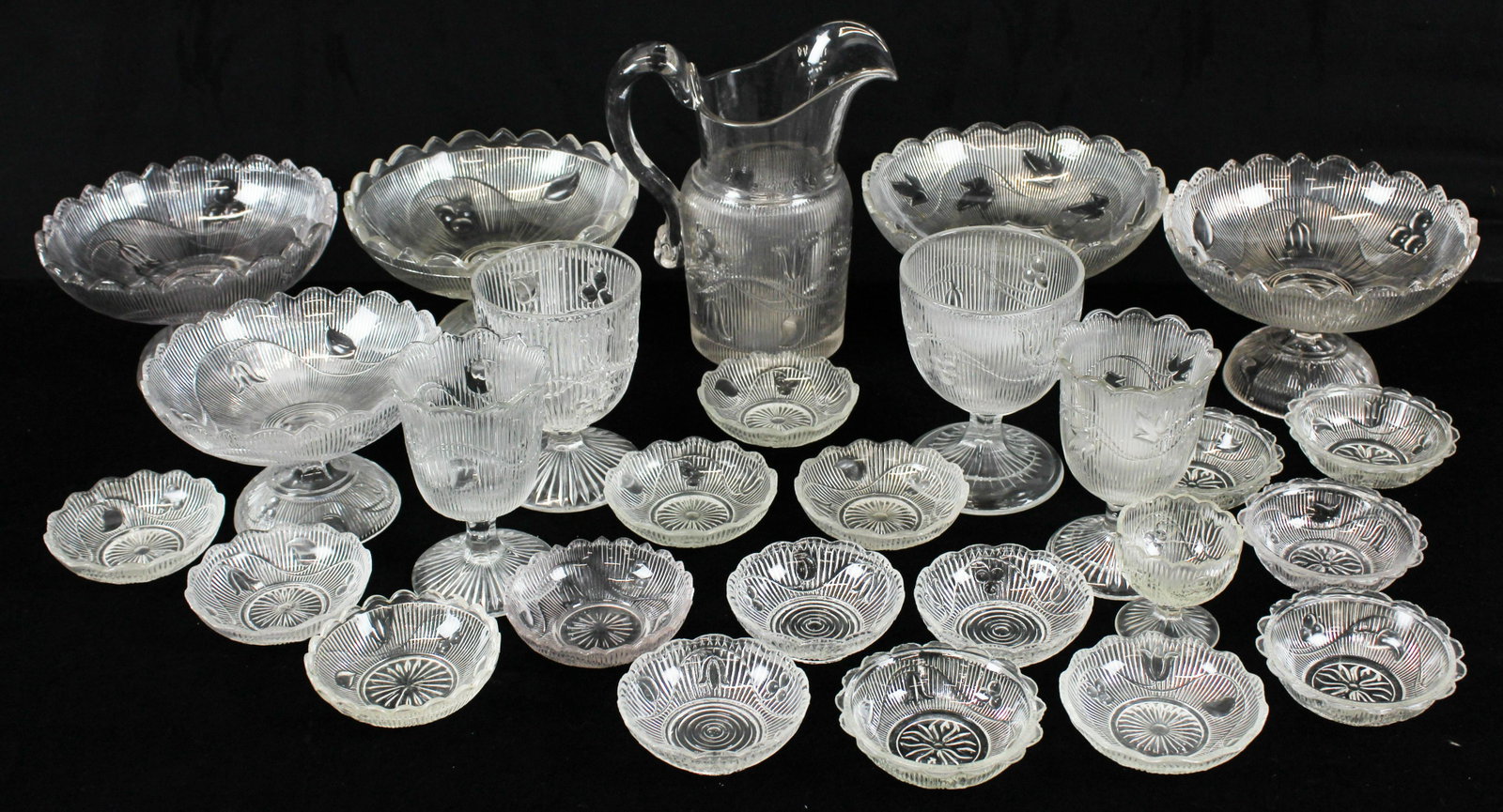 27 pcs. Ribbed Bellflower and Ivy Pattern Glass: Group of 27 pcs. Ribbed Bellflower and Ribbed Ivy colorless Early American Pattern Glass EAPG tableware items including fine pitcher with blown applied handle and ground pontil base, 5 compotes, 2 spo