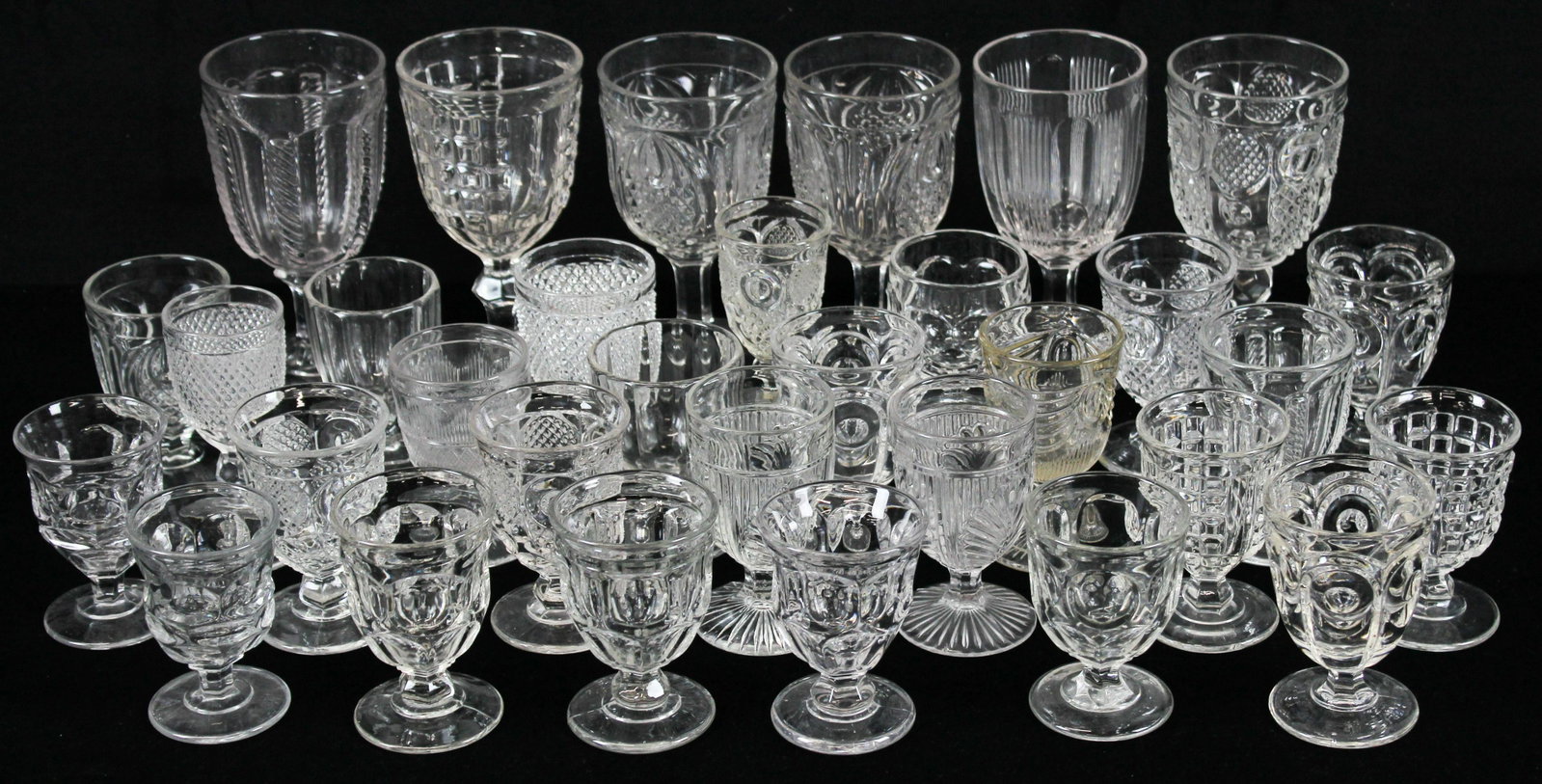 32 Early American Pattern Glass Goblets: Collection of 32 Early American Pattern Glass EAPG goblets in assorted patterns to include "Cable", "Ribbed Acanthus", "Ashburton", "New England Pineapple", "Horn of Plenty", "Waffle", and others ht. 