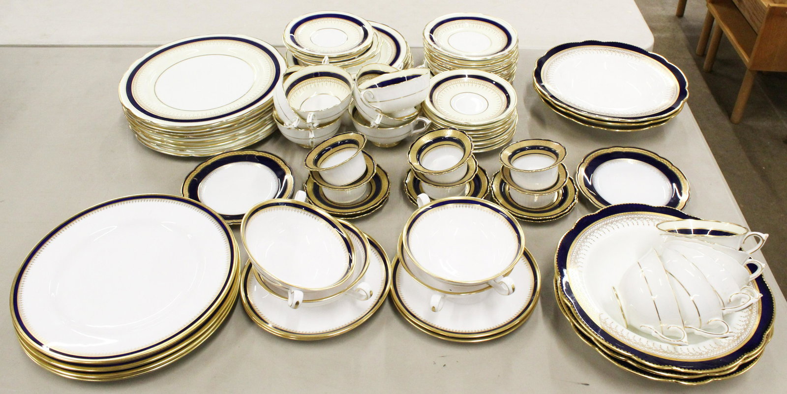 Cobalt and Gold Band Dinnerware Incl. Spode: Lot of assorted cobalt and gold banded porcelain dinnerware including 6 Coalport soup bowls, 6 Spode dinner plates and 6 consomme soups with saucers, 6 Hutschenreuther ramekins and under plates with t
