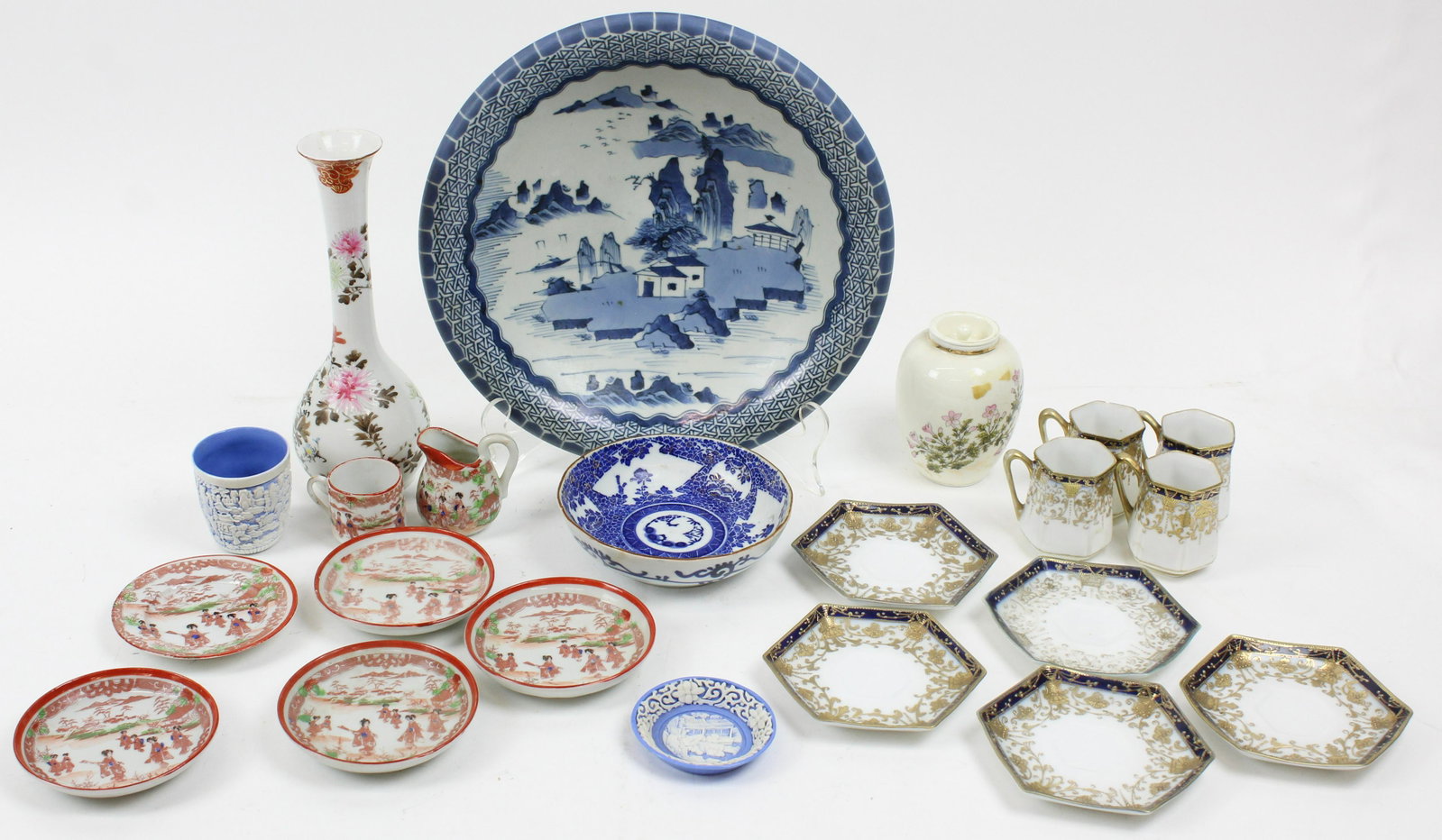 Group of Assorted Japanese Porcelain Items: Group of assorted 19th and 20th c. Japanese porcelain items including tall bud vase, blue and white decorated bowl, white over blue scenic carved handleless cup and saucers, 4 Nippon demitasse cups an
