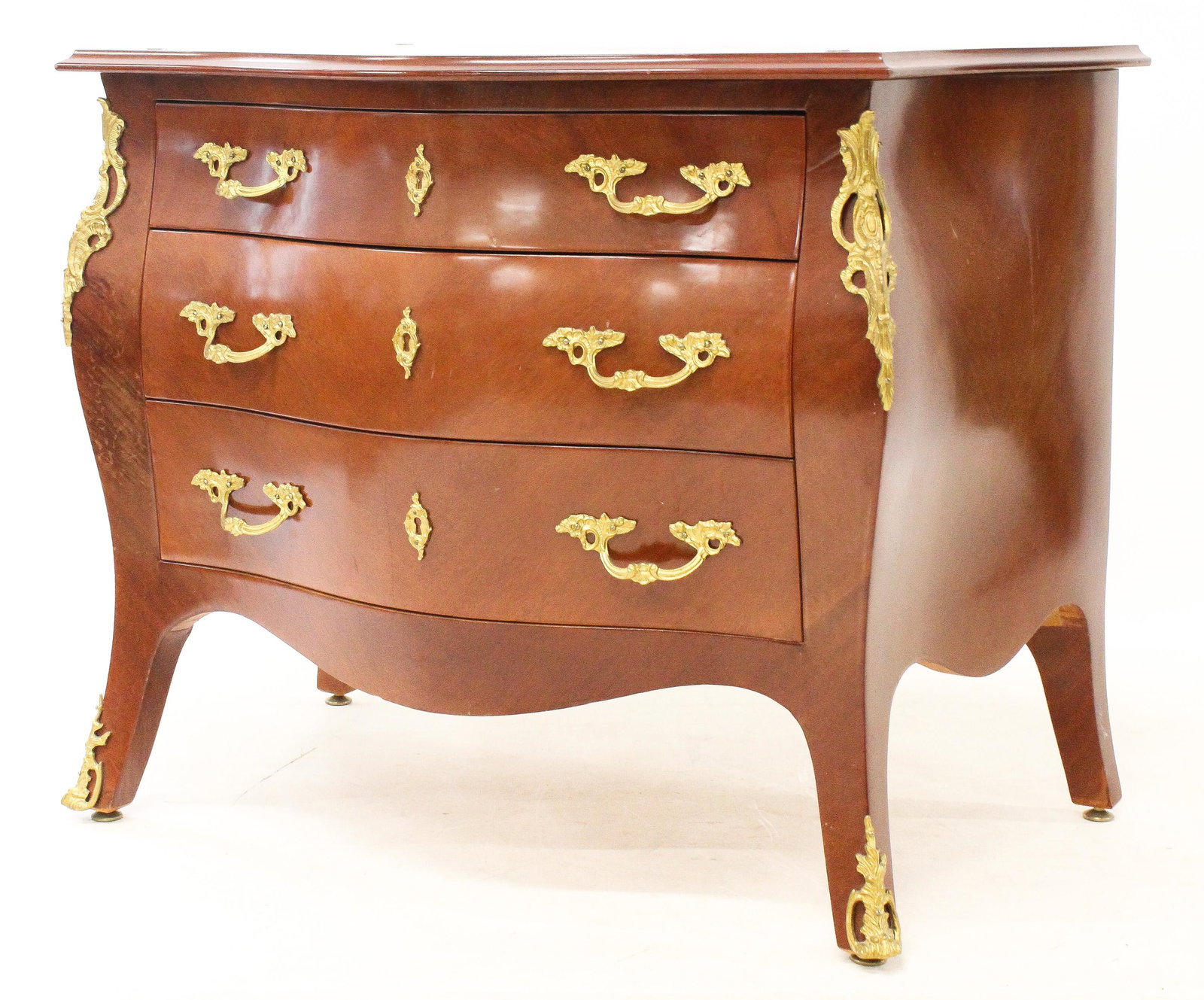 Continental Style Ormolu Mounted Bombe Chest: Continental style ormolu mounted cherry bombe chest/ commode, case width 33", top width 35", ht 28"