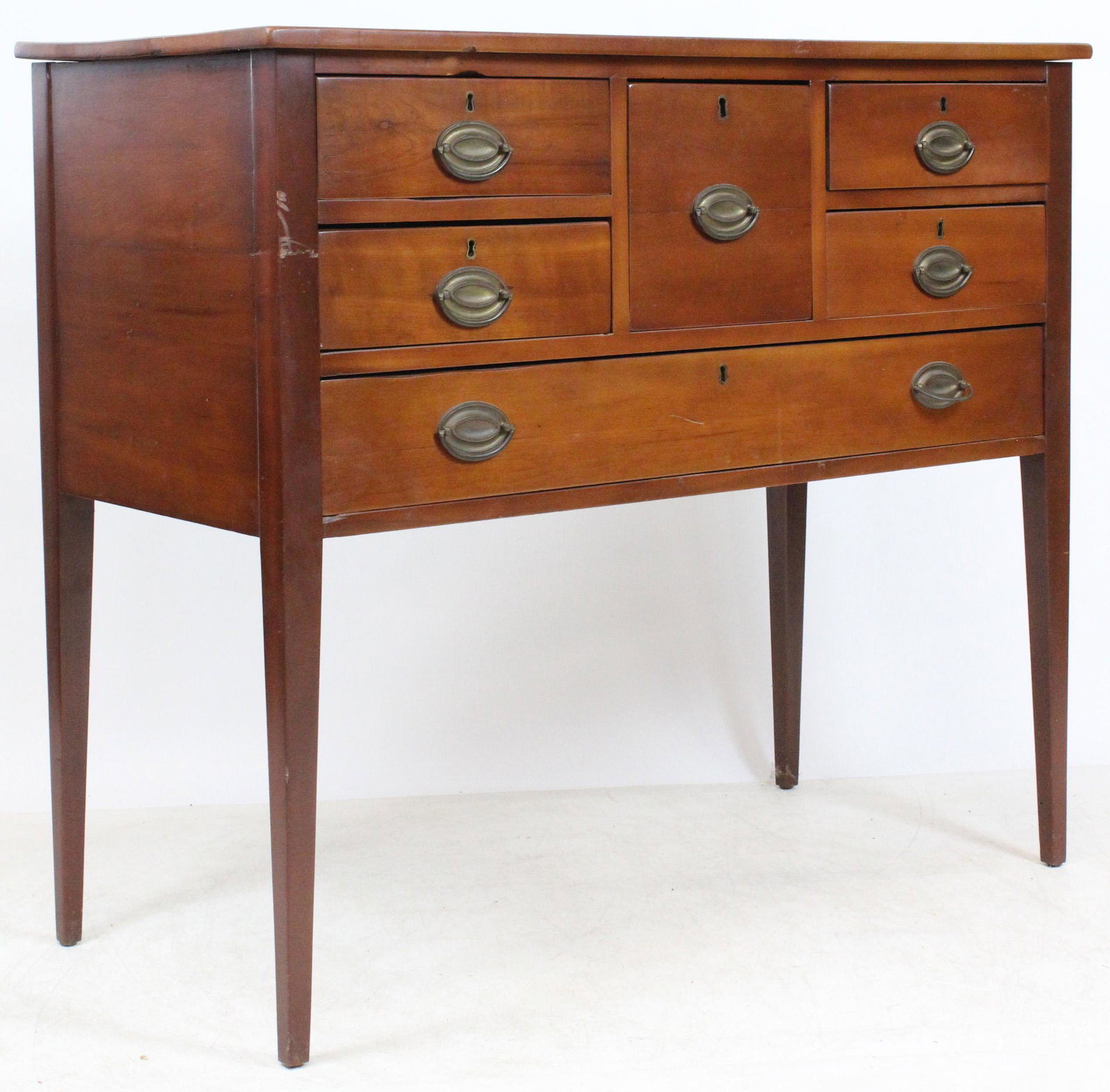 Hepplewhite Half Sideboard: Ca. 1800 Hepplewhite cherry 6 drawer half sideboard. Center liqueur drawer, two drawers either side and long single drawer below. Tall taper legs, replaced oval pulls, restored top, very clean. 42" w,