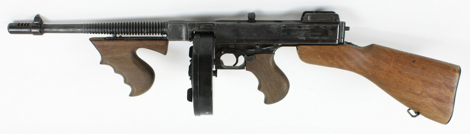 Thompson "Tommy Gun" Replica Cap Firing Replica: M1921 Thompson Sub-Machine gun cap firing replica (non-firing). Manufactured by MGC (Model Gun Corporation), Tokyo, Japan. 33 inches in length. Operational bolt, removable stock, functioning safety an