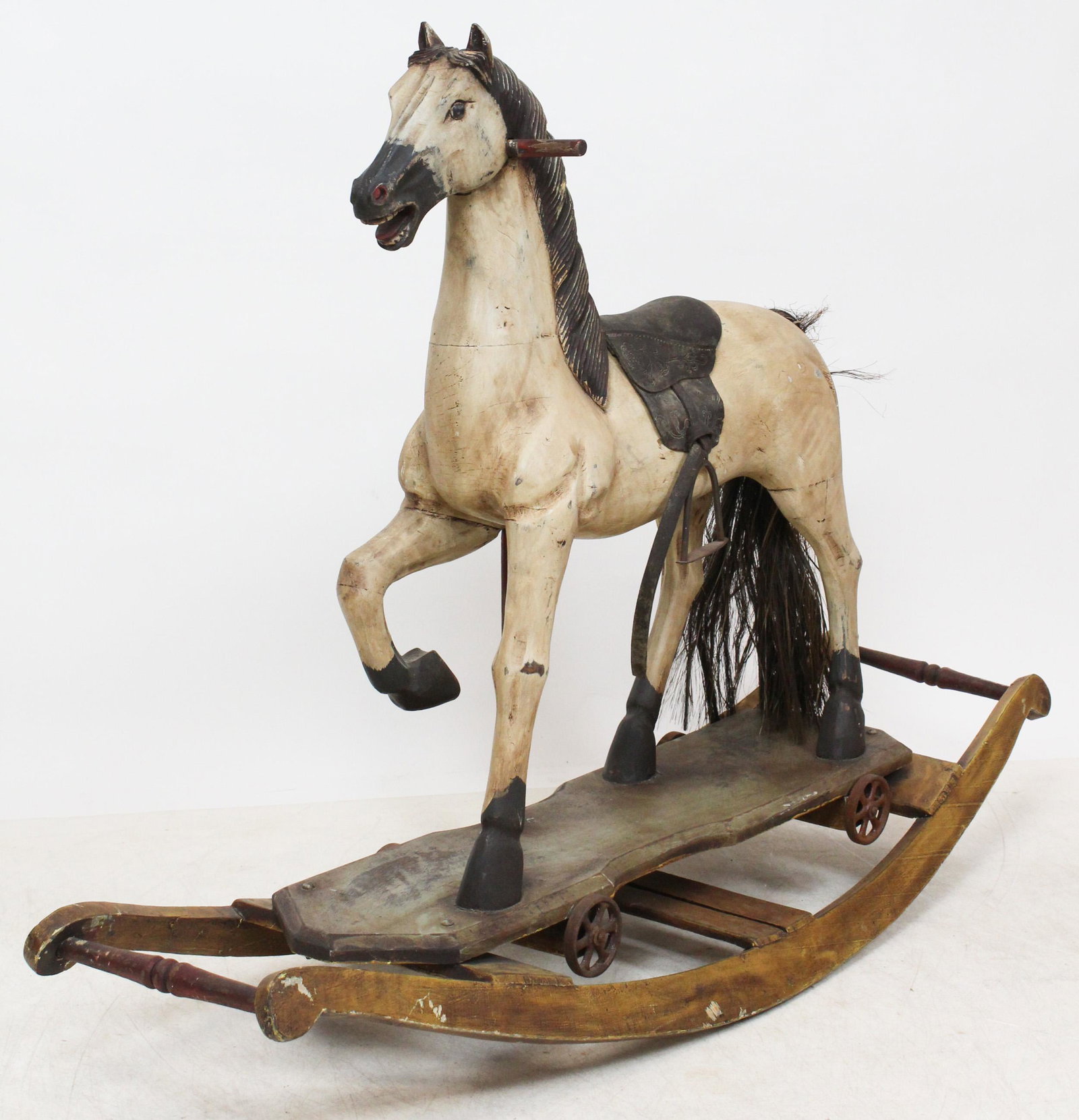 Reproduction Rocking Horse with Wheels: Reproduction carved and painted rocking horse with wheels, ca 1980, overall length 48", ht 34"