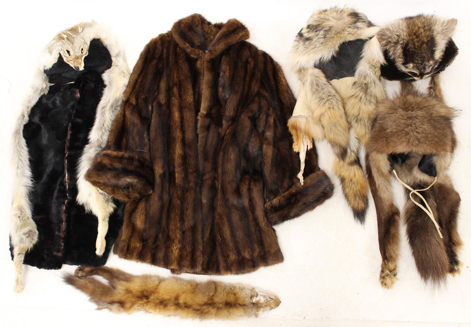 Fur Hats Coats and other assorted Furs: Wolverine and Coydog hats in very nice condition. Mink coat in decent condition, some tears in the fur and the liner around the armpit. Other Assorted animal furs included, not in great shape.