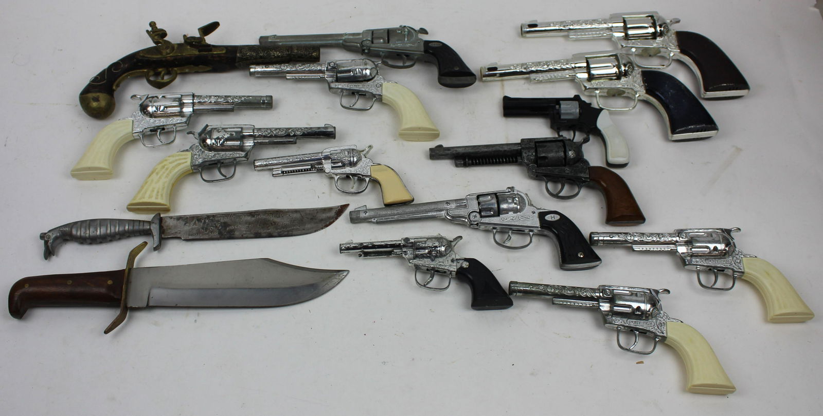 Collection of Cap Guns: Collection of Cap guns, reproduction flintlock (with non functioning brass frizzen) two knives.