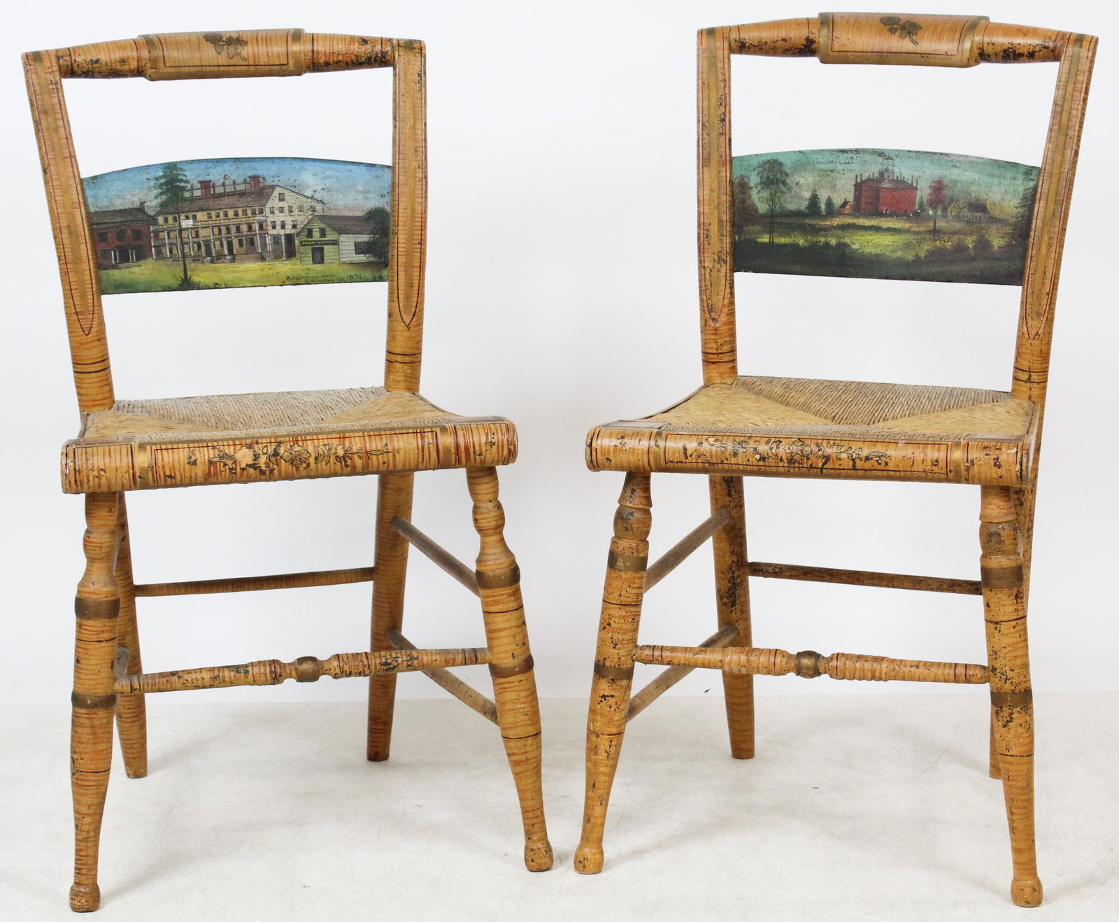 Burlington, VT Fancy Chairs: A Pair of ca. 1830 Burlington, Vermont paint decorated fancy chairs. Faux tiger maple, gilt & red faux inlay painted pillow back chairs. Center panels painted with Burlington landscapes. Later panels 