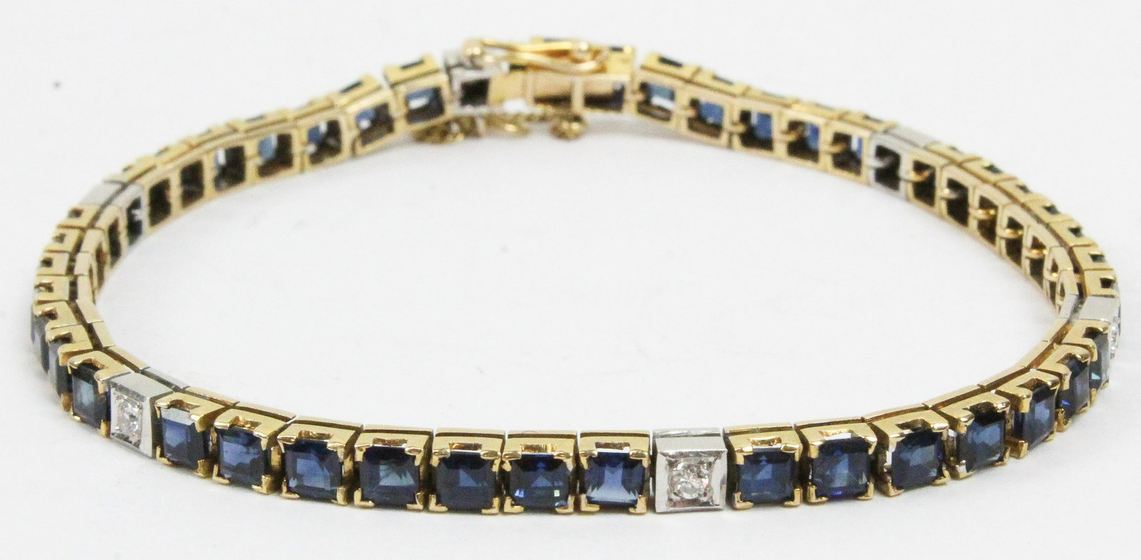Diamond & Sapphire Tennis Bracelet: 14k two tone tennis bracelet set with 42 round cut sapphires approx. 4 cts. Total weight. Set with 6 round cut diamonds approx. .36 cts.tw. 6 7/8" long.