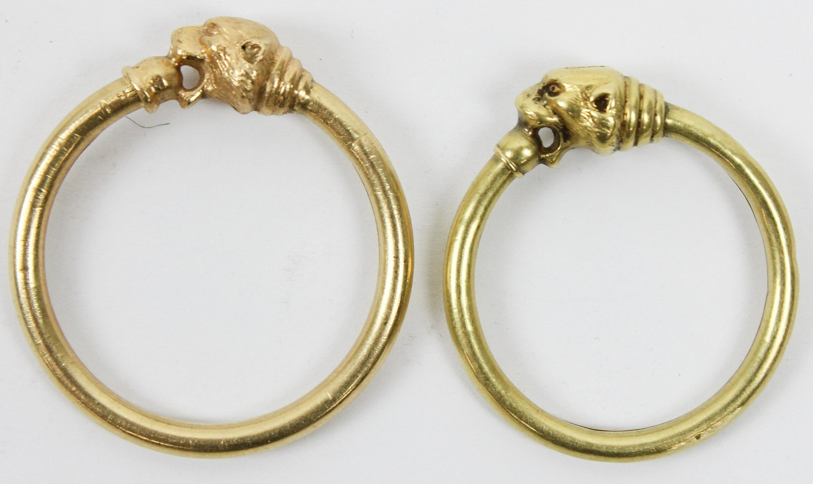Pair of Lion Head 14k Hoops: A pair of hoops with lion heads that open by flexing the loop back out of lions mouth. Test 14k, 11.1 grams t.w. One loop slightly larger than other. 1 3/8" diameter. From the estate of J.P Morgan.