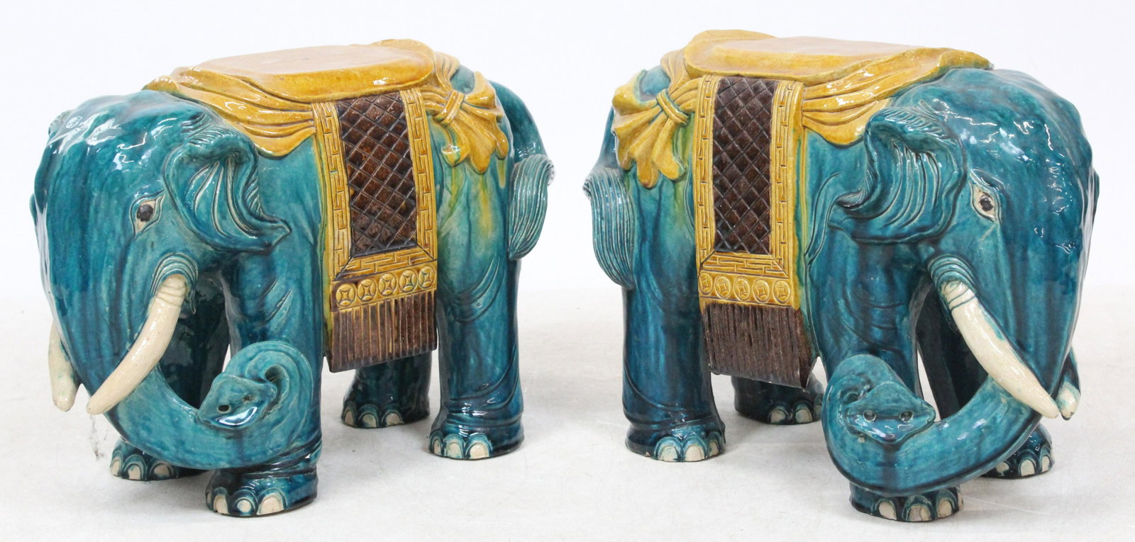 A Pair of Chinese Elephant-Form Stools: A pair of Chinese elephant-form pottery stools or garden seats, polychrome glaze, length 20", height 14 1/2", sold by Christie's Oct 20th, 2004 (lot 636), ex Iris Love