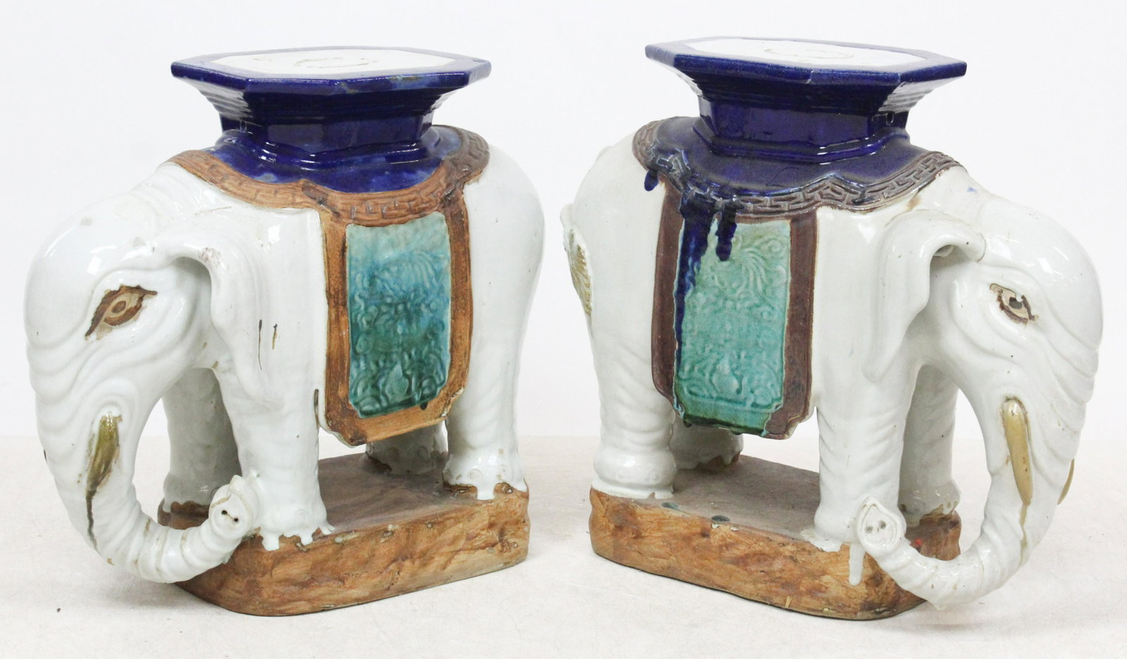 A Pair of Chinese Elephant-Form Stools: A pair of Chinese elephant-form pottery stools or garden seats, polychrome glaze, length 23", height 21 1/2", sold by Christie's Oct 20th, 2004 (part of lot 637), ex Iris Love