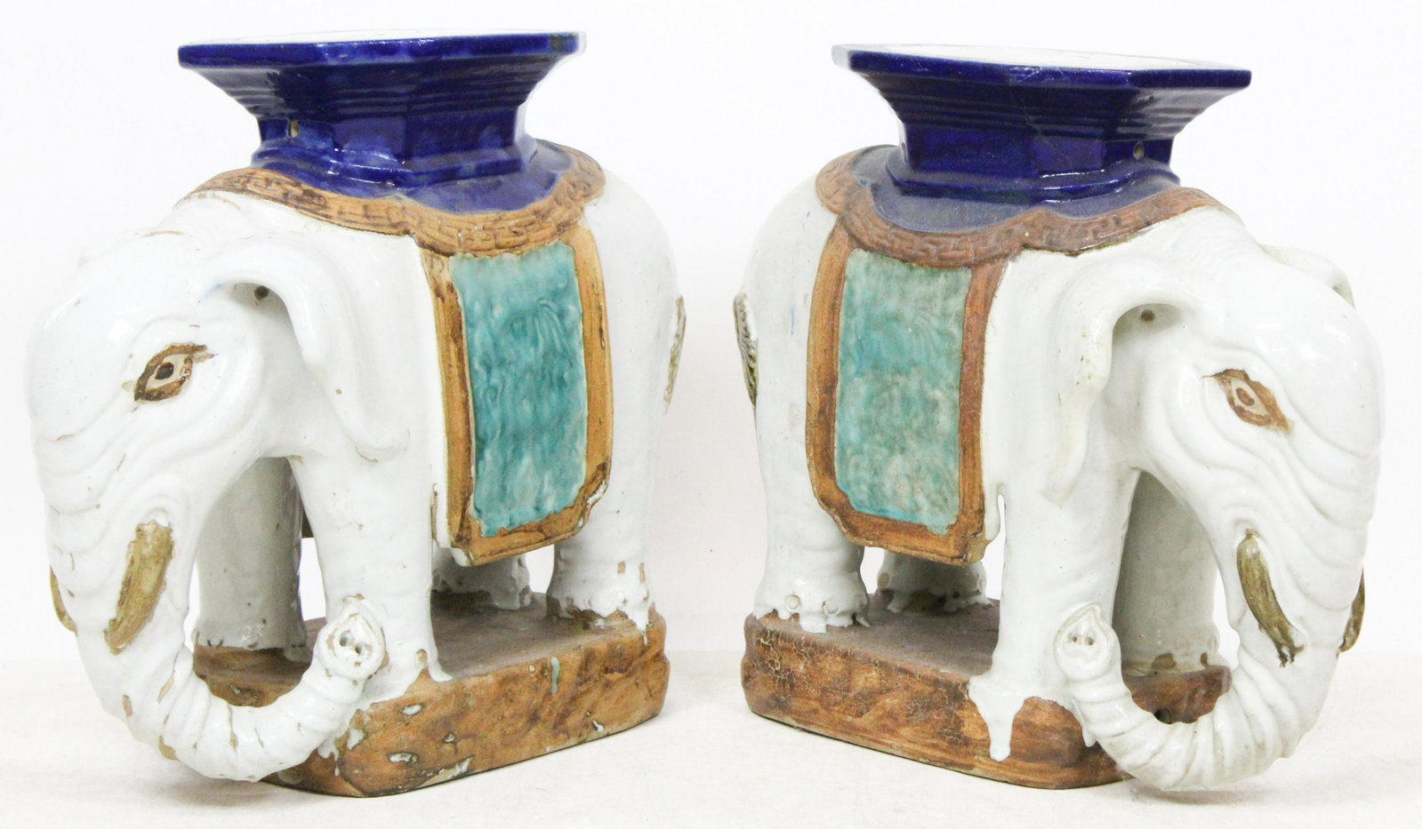 A Pair of Chinese Elephant-Form Stools: A pair of Chinese elephant-form pottery stools or garden seats, polychrome glaze, one has large repair to ear, length 23", height 21 1/2", sold by Christie's Oct 20th, 2004 (part of lot 637), ex Iris 